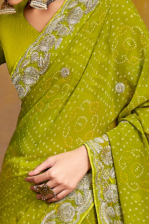 Green Georgette Saree Adorned With Traditional Bandhani Prints & Intricate Floral Embroidery