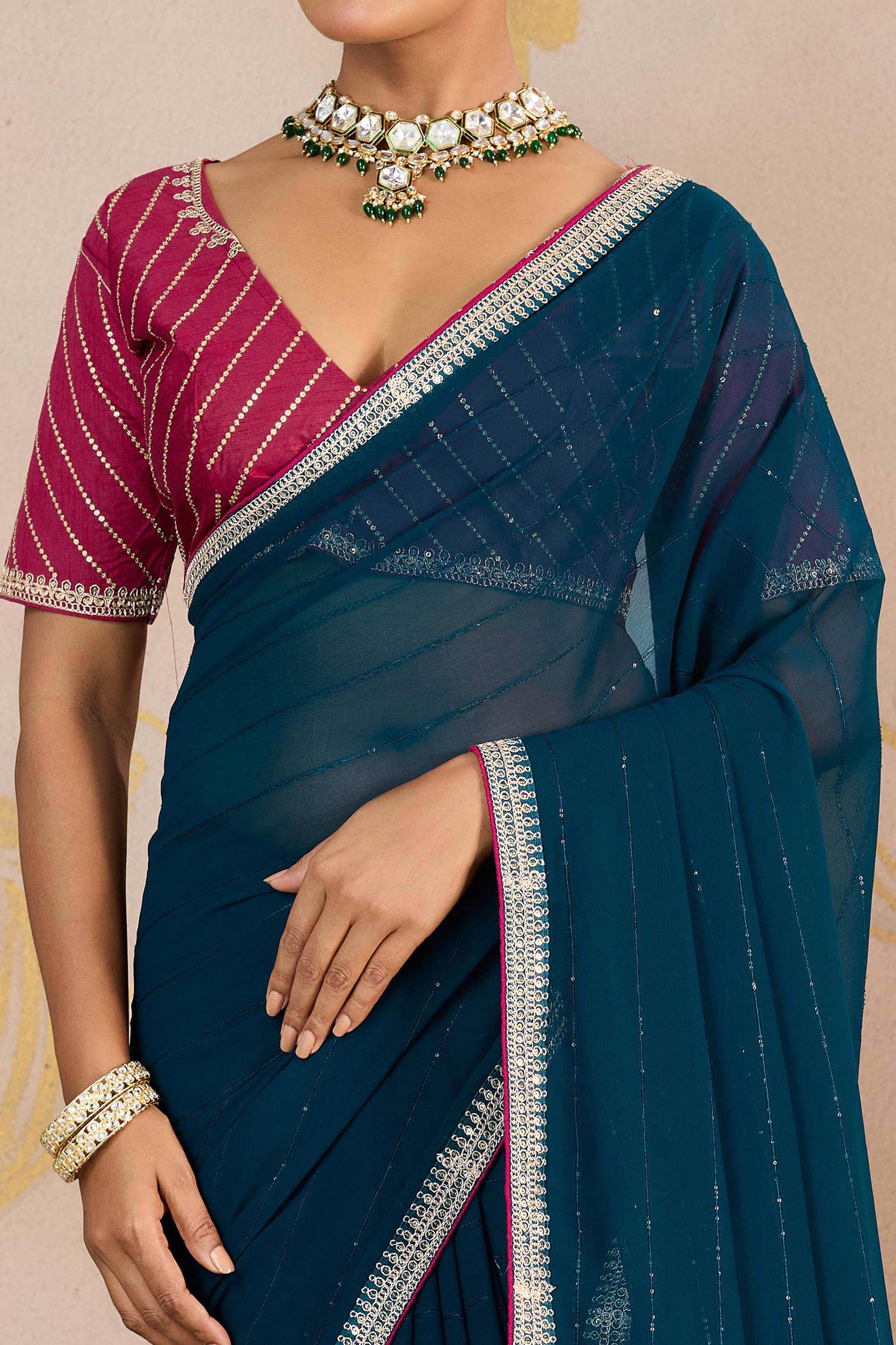 Teal Zari Embroidered Georgette Saree Accented With Sequins