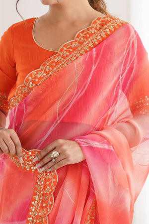 Graceful Orange Foil Print Georgette Saree Featuring A Luxurious Cording Sequins Embroidered Border