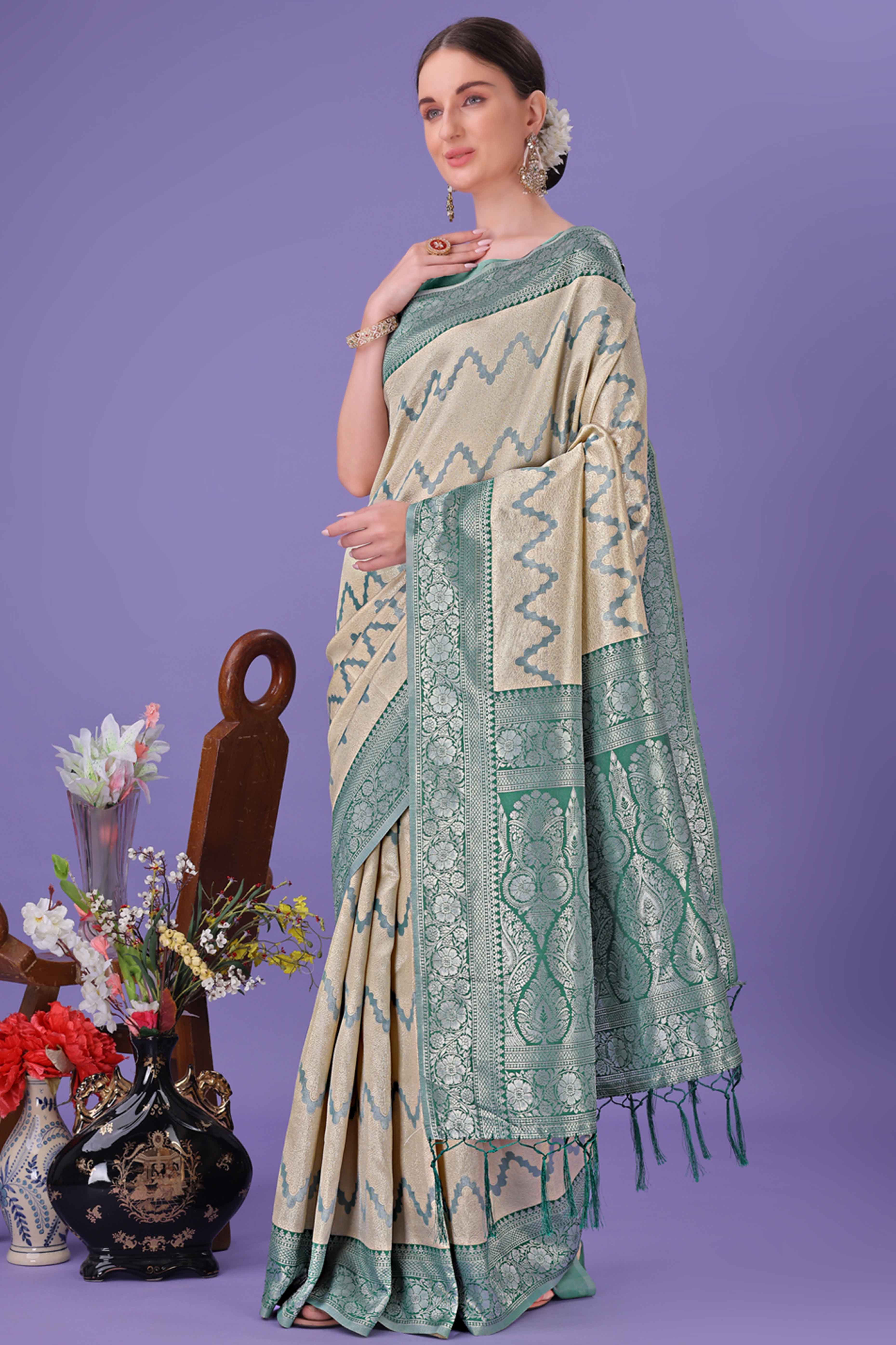 Cream Lichi Cotton Silk Saree Adorned With Floral Zari Weave & Tassels