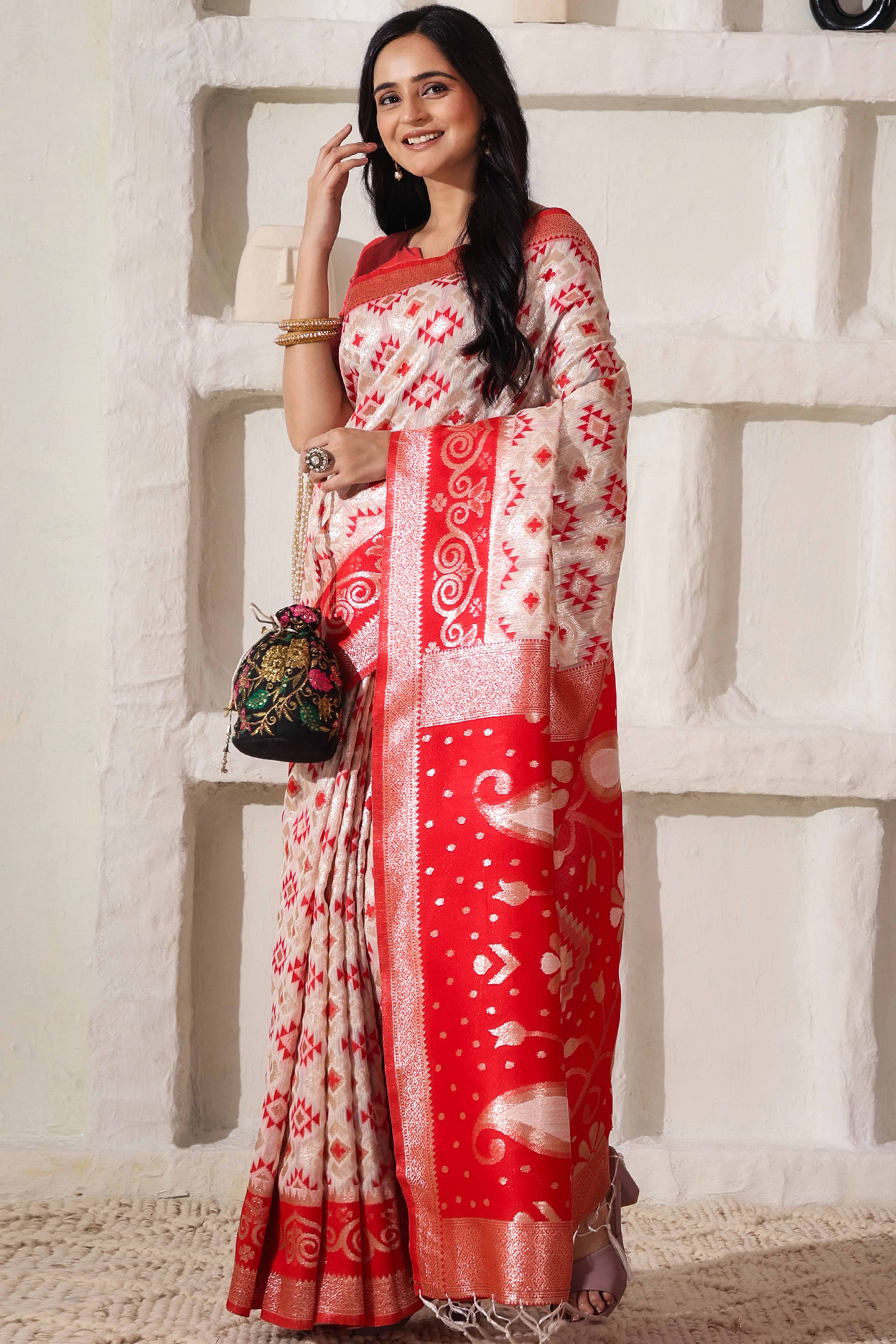 White & Red Linen Cotton Saree Featuring Fine Zari Weaving And A Tasselled Finish