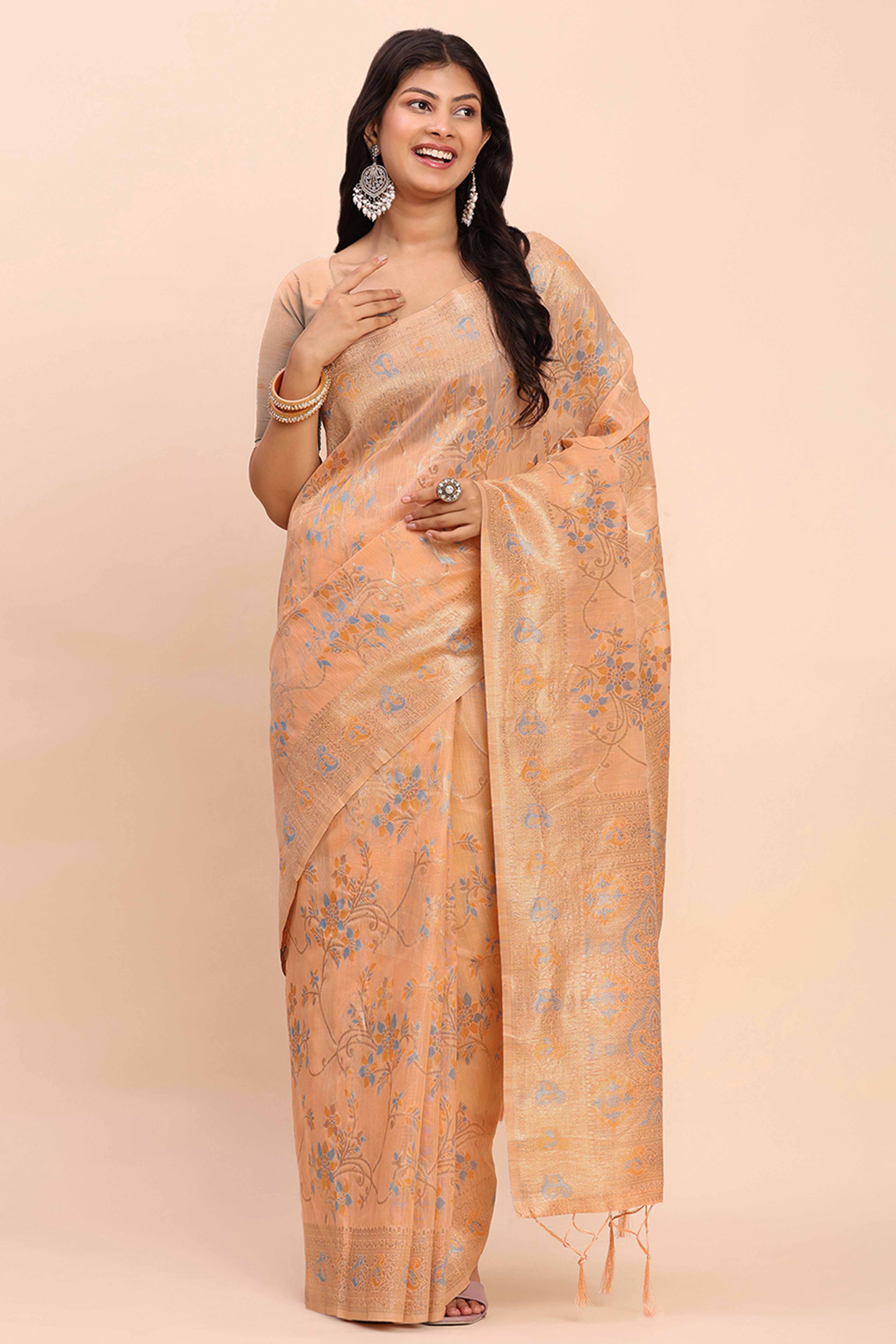 Light Orange Linen Cotton Saree Showcasing Floral Zari Weaves & A Tasselled Finish Pallu