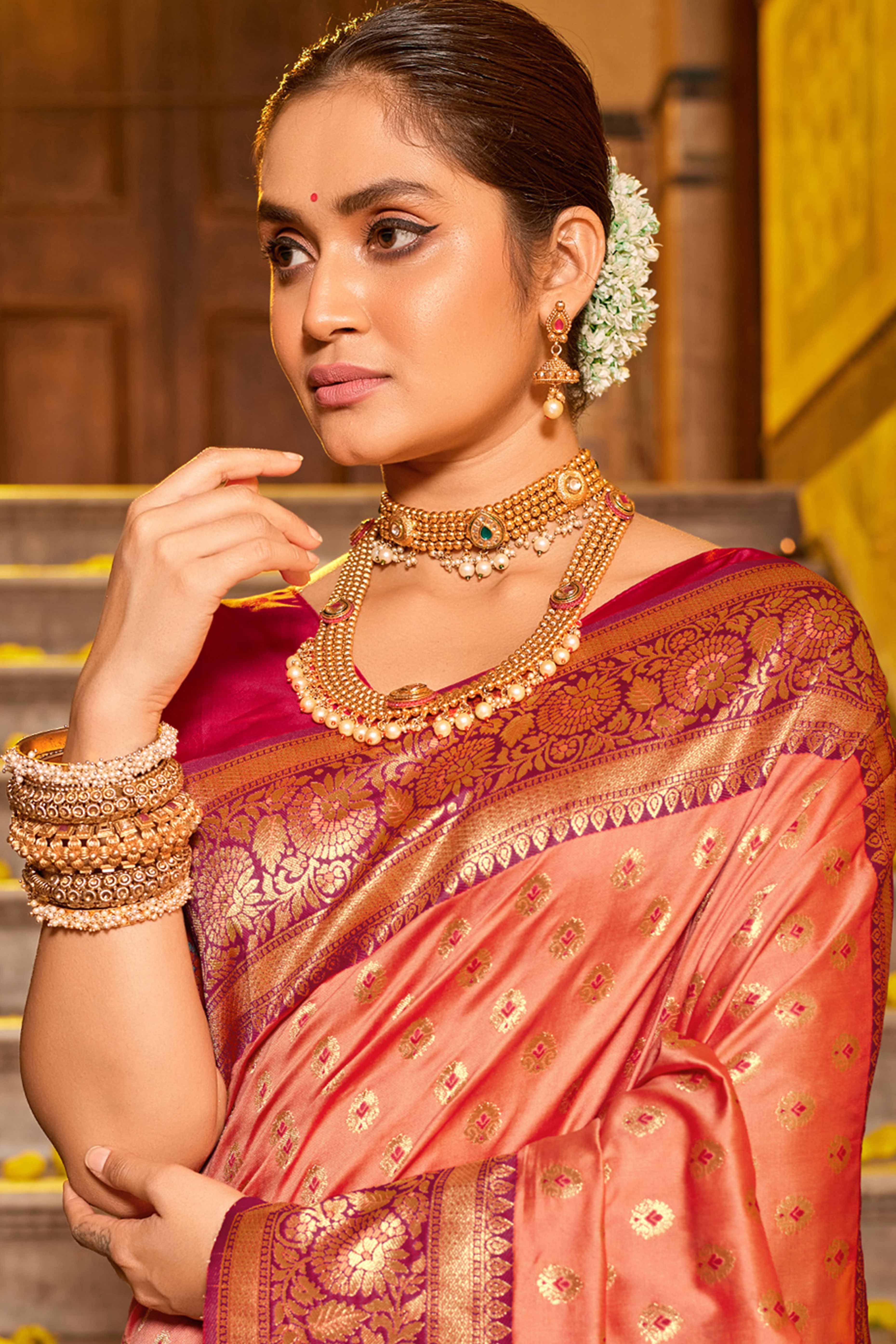 Peach Banarasi Silk Saree Featuring Intricate Floral Weaving & Elegant Tassel Pallu