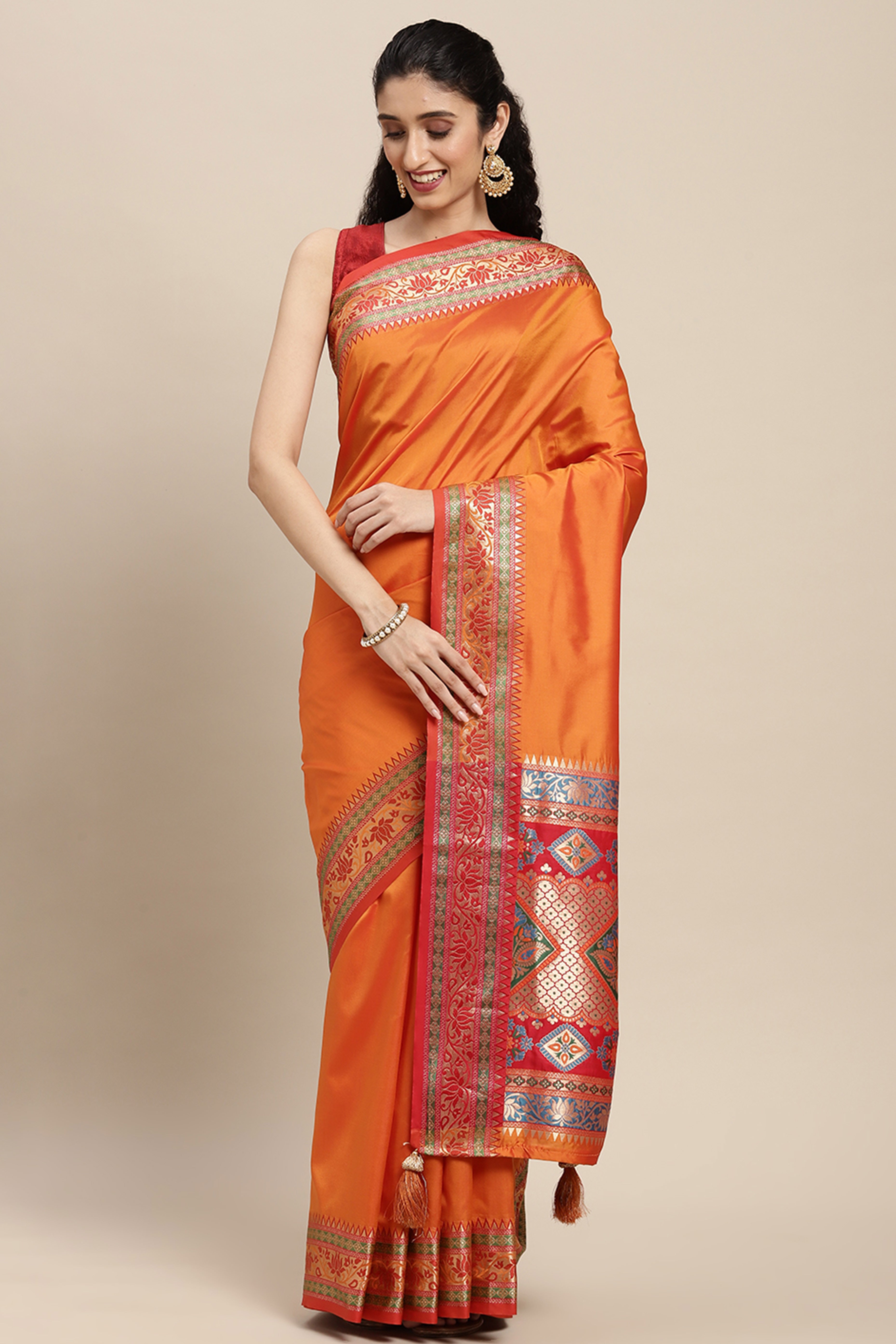 Graceful Orange Solid Saree Highlighted With Floral Zari Weaving On Silk Blend & Tassel Pallu
