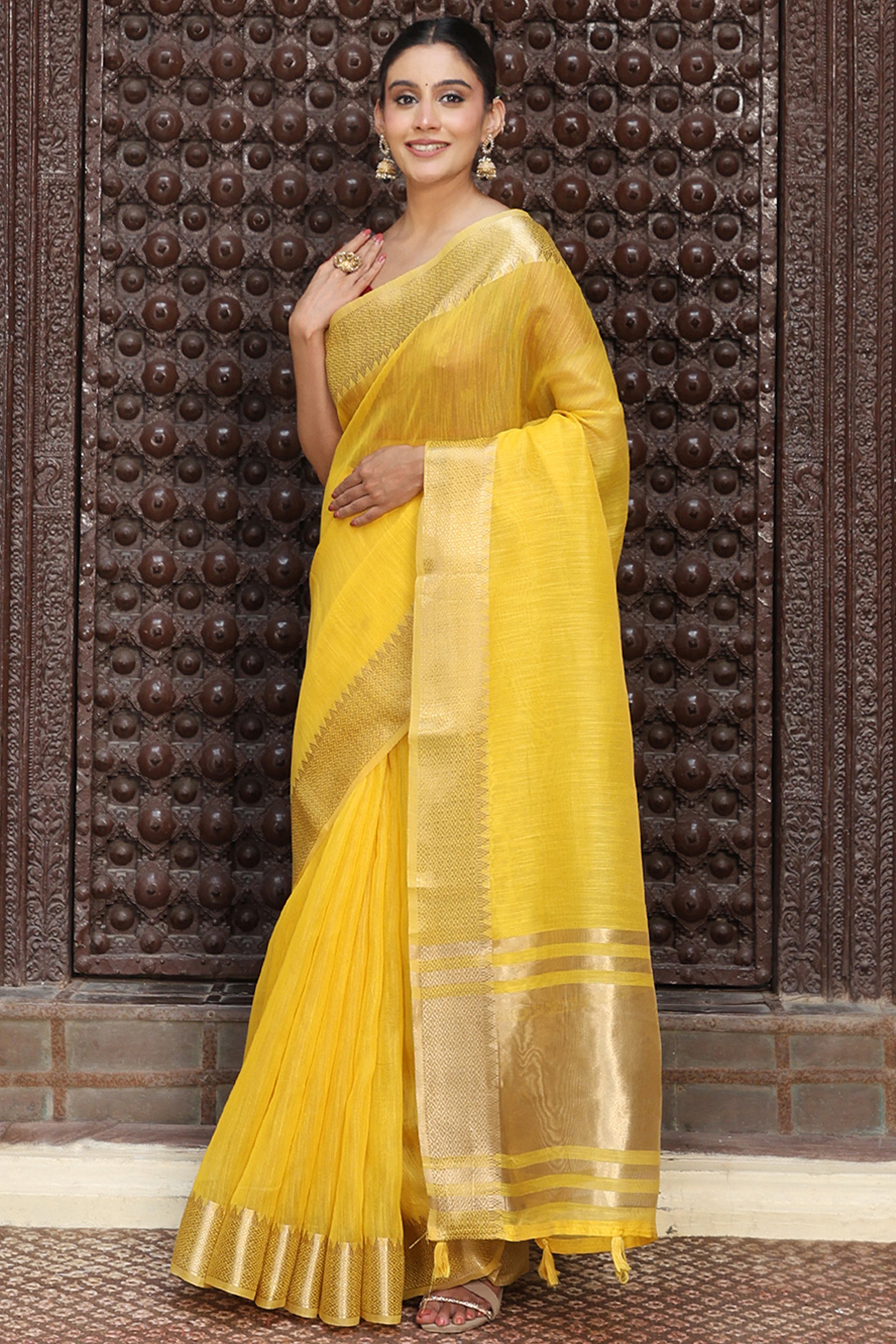Trendy Yellow Cotton Blend Saree Showcasing Elegant Zari Weaving & Tassel Border Pallu
