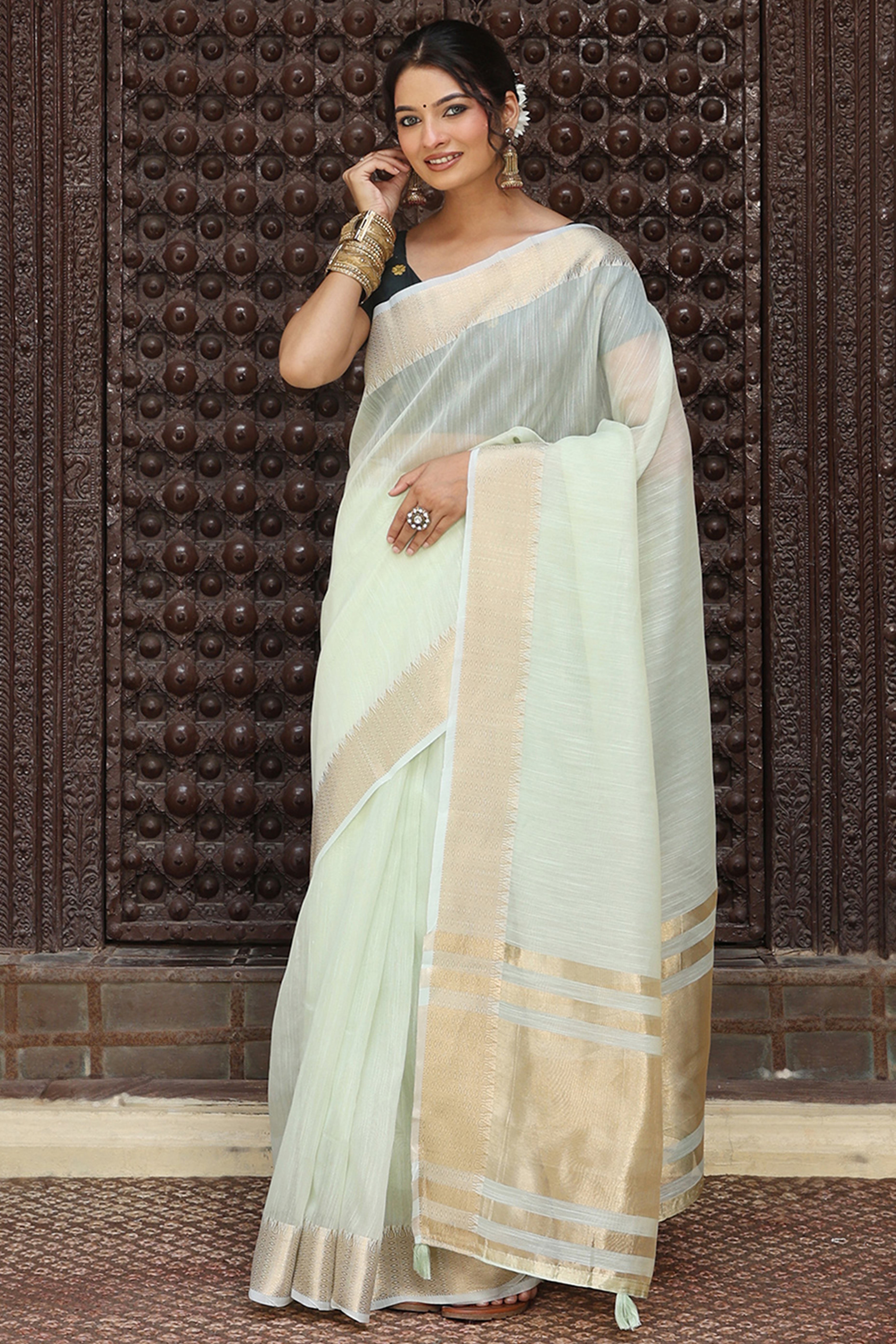 Charming Light Sea Green Zari Weaving Cotton Blend Saree Adorned With Stylish Tassel Detailing