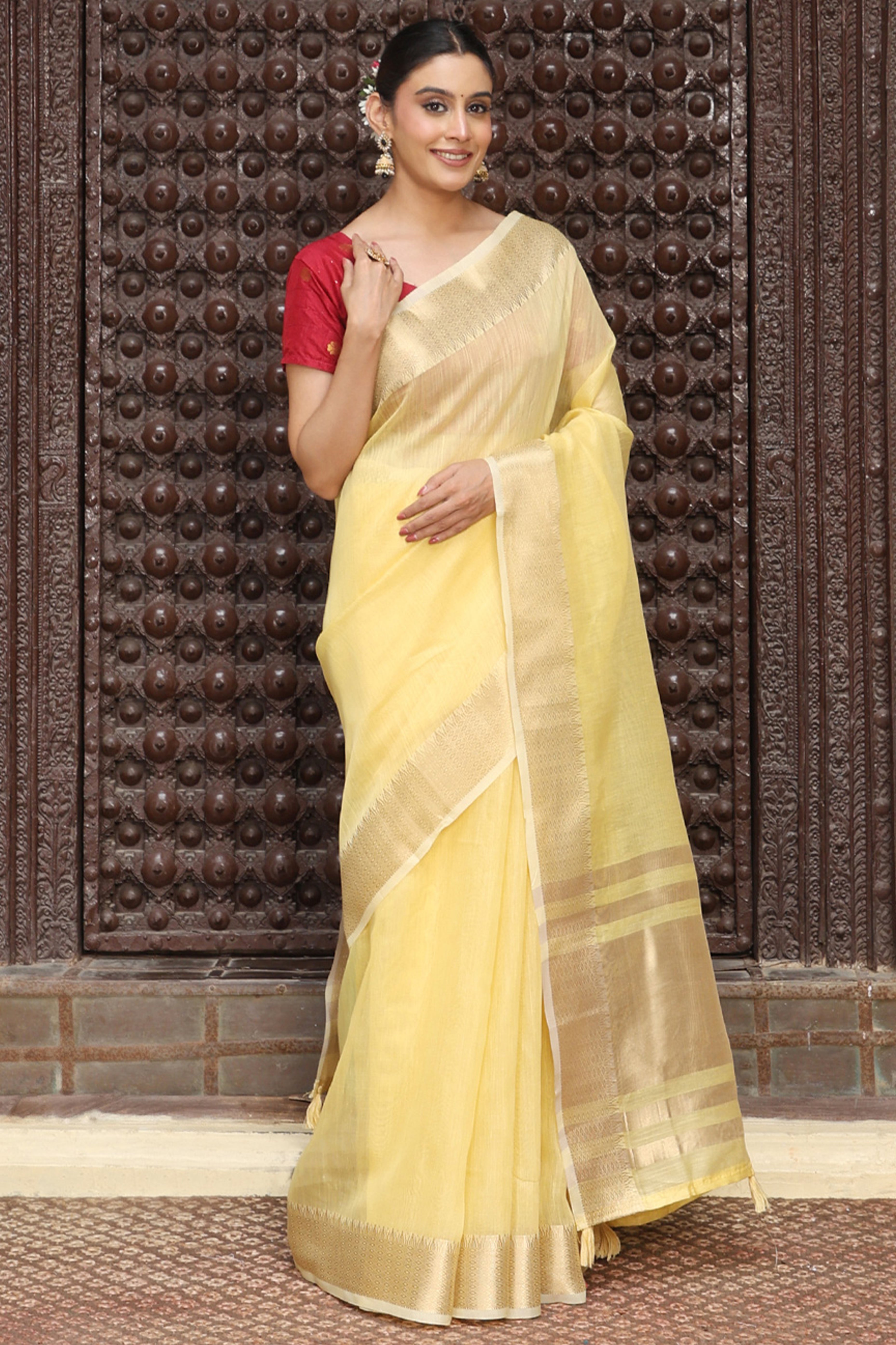Charming Yellow Zari Weaving Cotton Blend Saree Adorned With Stylish Tassel Detailing
