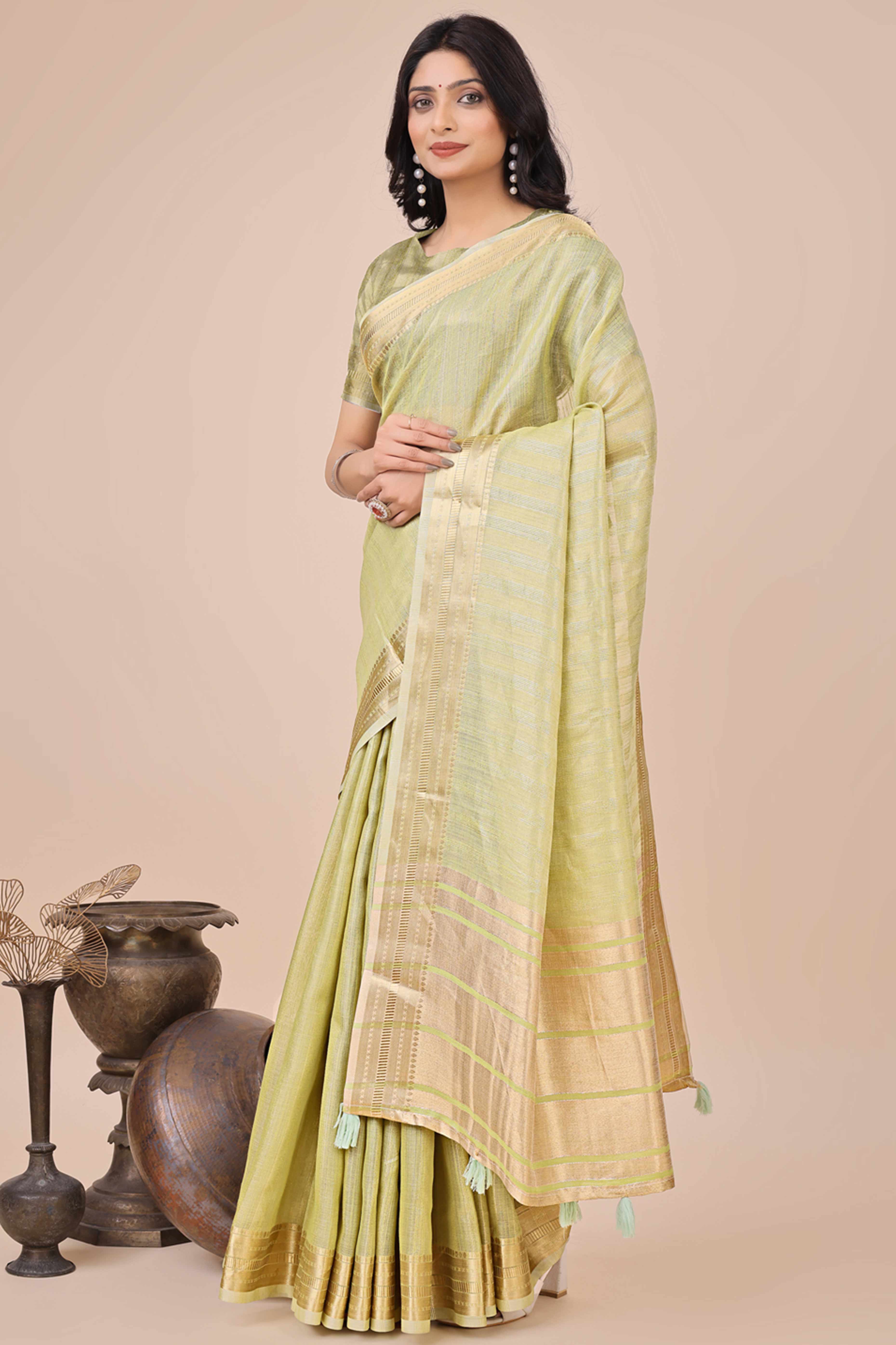 Light Green Organza Saree With Intricate Weave & Elegant Tassel Accents