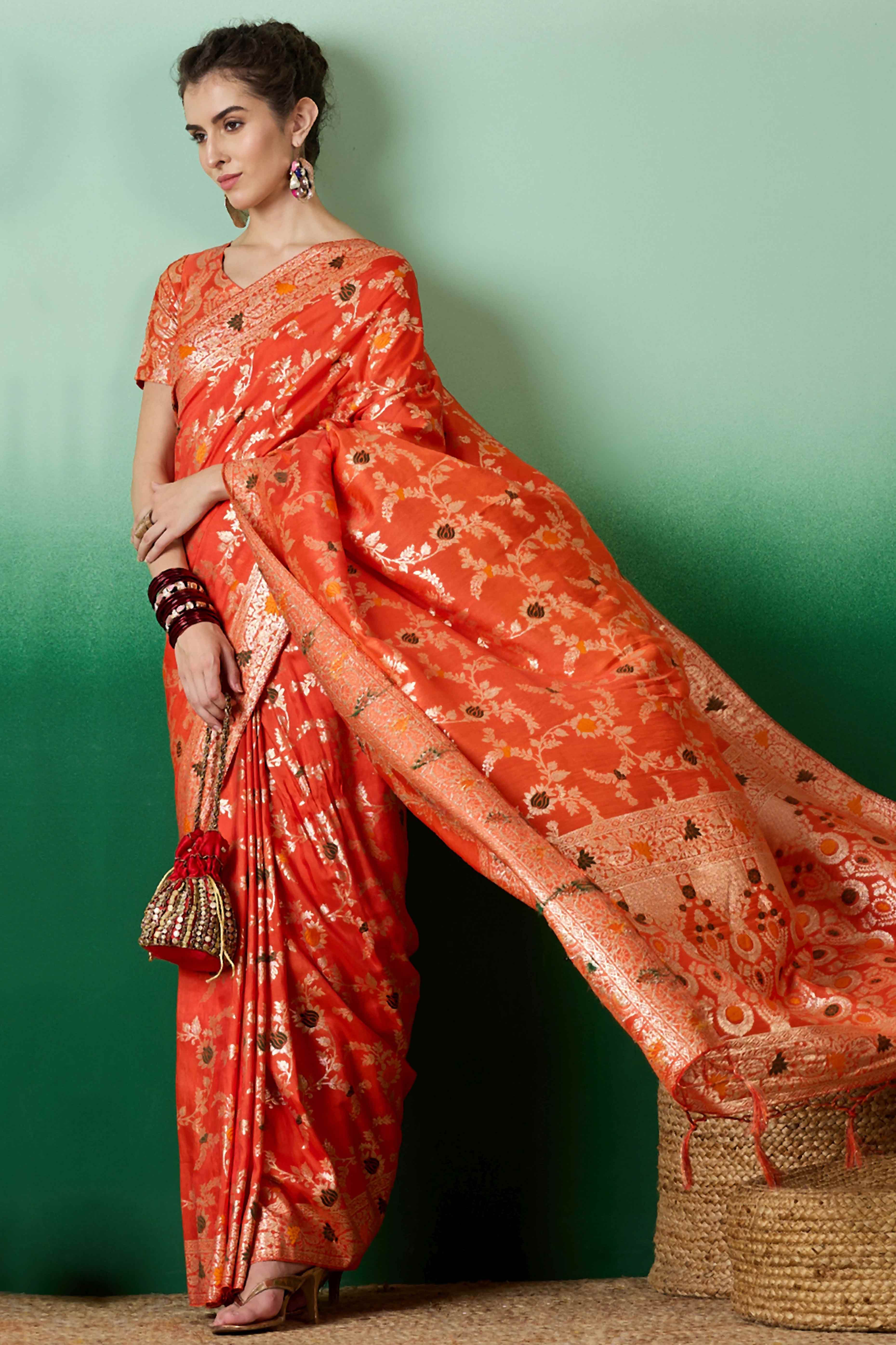 Orange Cotton Meena jacquard Saree Featuring Intricate Floral Weaving & Playful Tassels On The Pallu