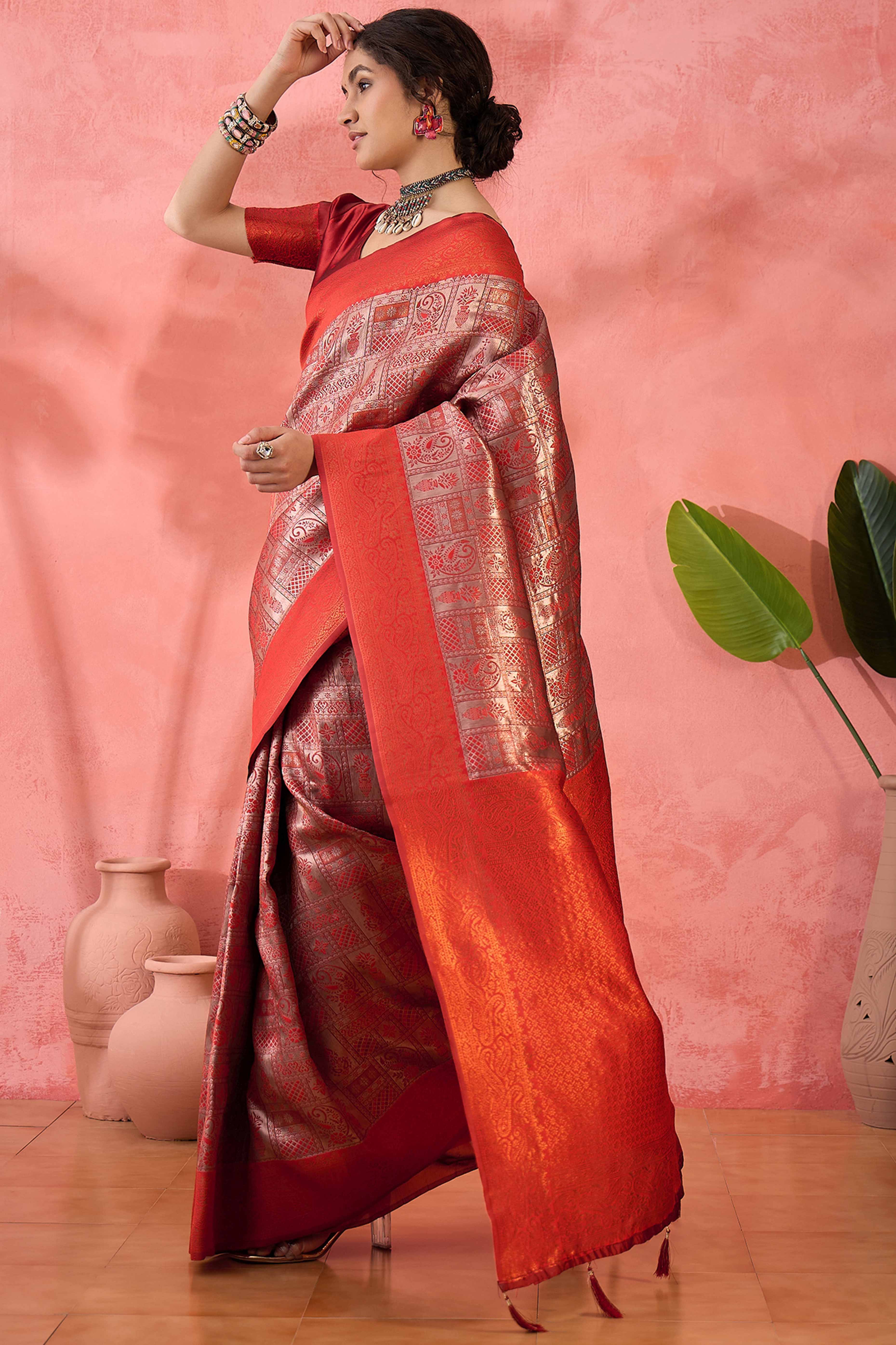 Rust Woven Poly Silk Blend Saree Featuring Floral & Paisley Motifs With Tassel Accents