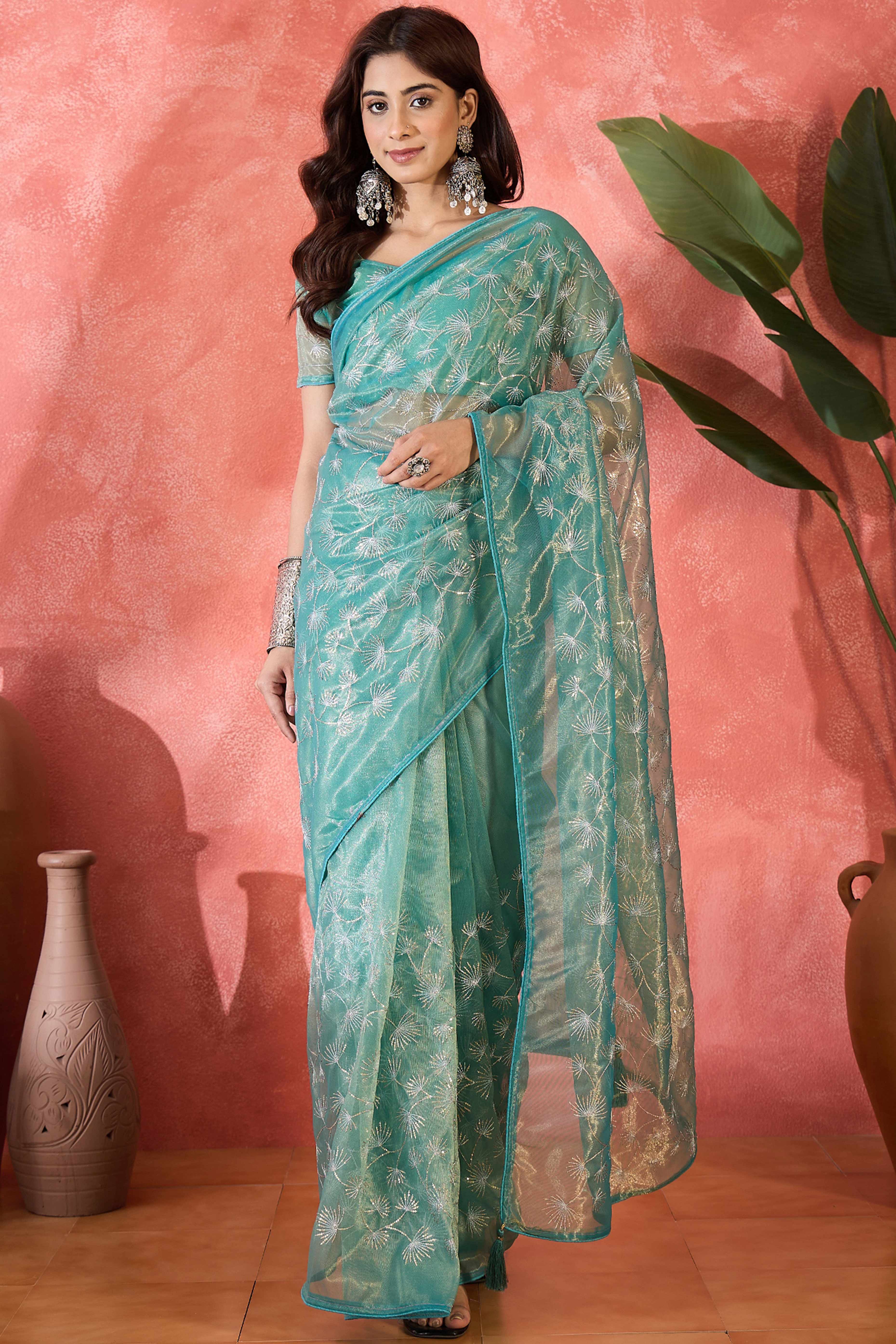 Turquoise Twill Net Saree With Intricate Floral Sequin Work & Flowing Tassel Pallu