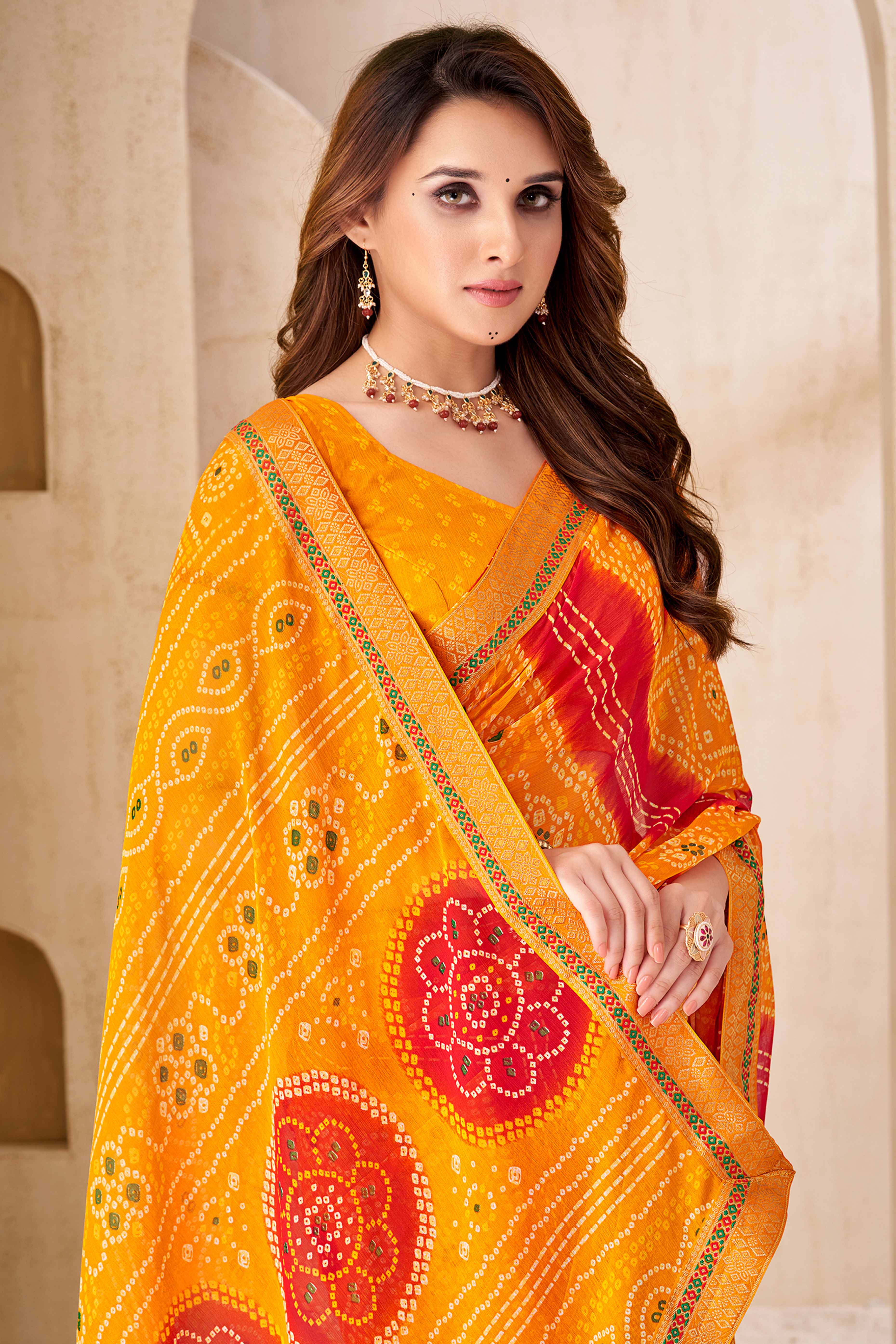 Bright Orange Bandhani Printed Chiffon Saree Enhanced with Delicate Lace Border Work