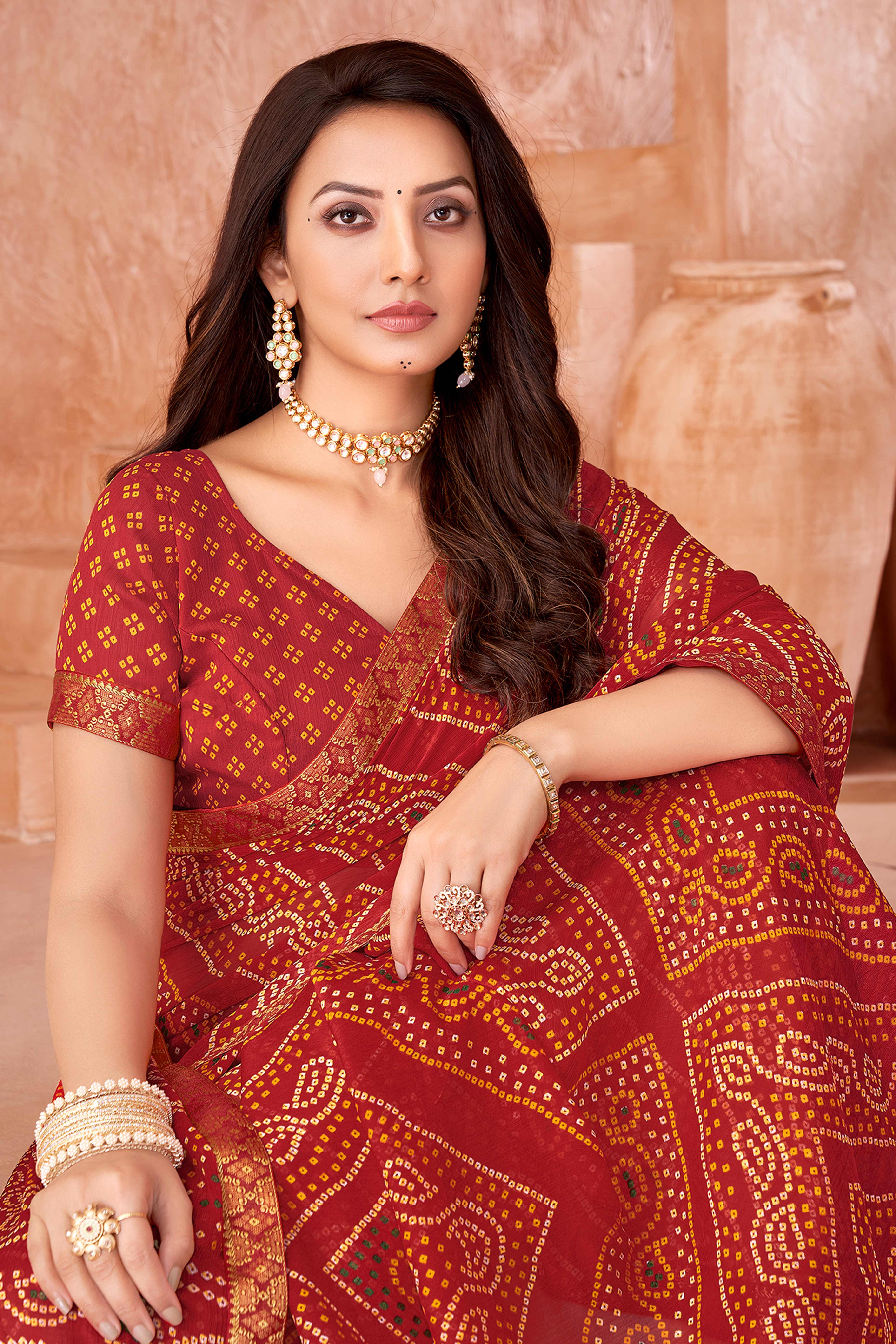 Red Chiffon Saree Featuring Traditional Bandhani Prints & A Graceful Lace Edge