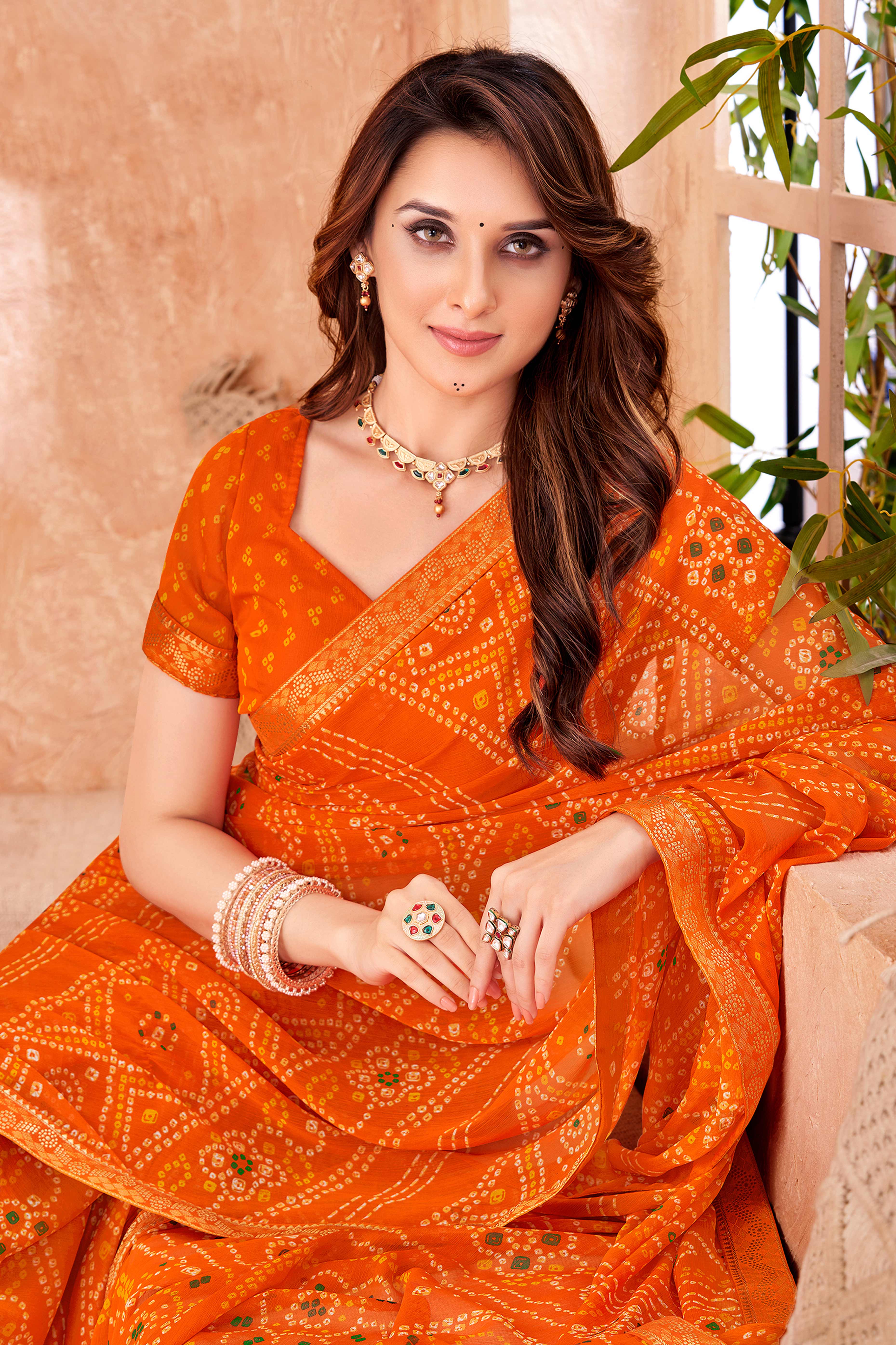 Orange Chiffon Saree Featuring Traditional Bandhani Prints & A Graceful Lace Edge