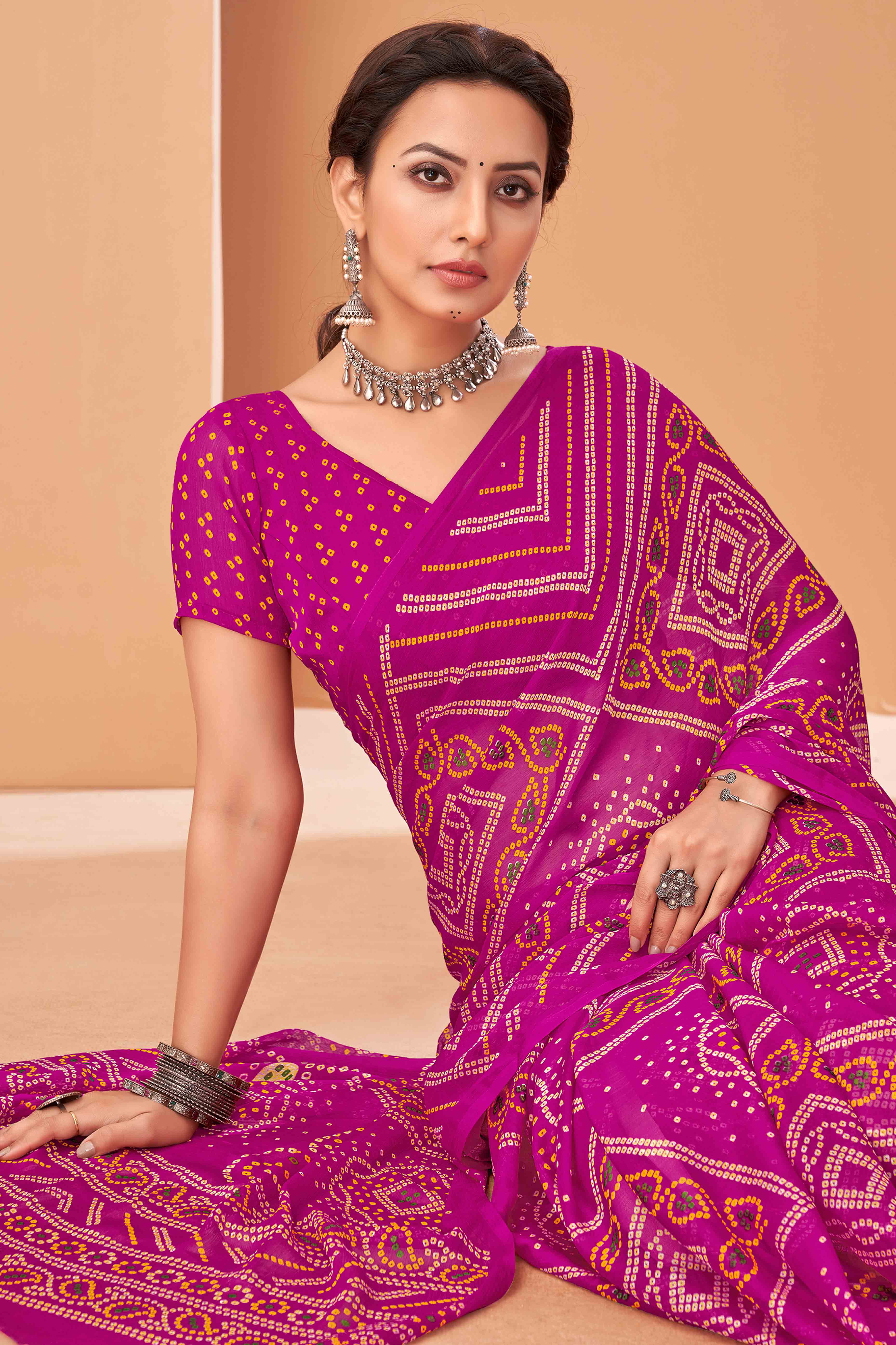 Magenta Bandhani Printed Chiffon Saree Accented With Intricate Lace Border Work