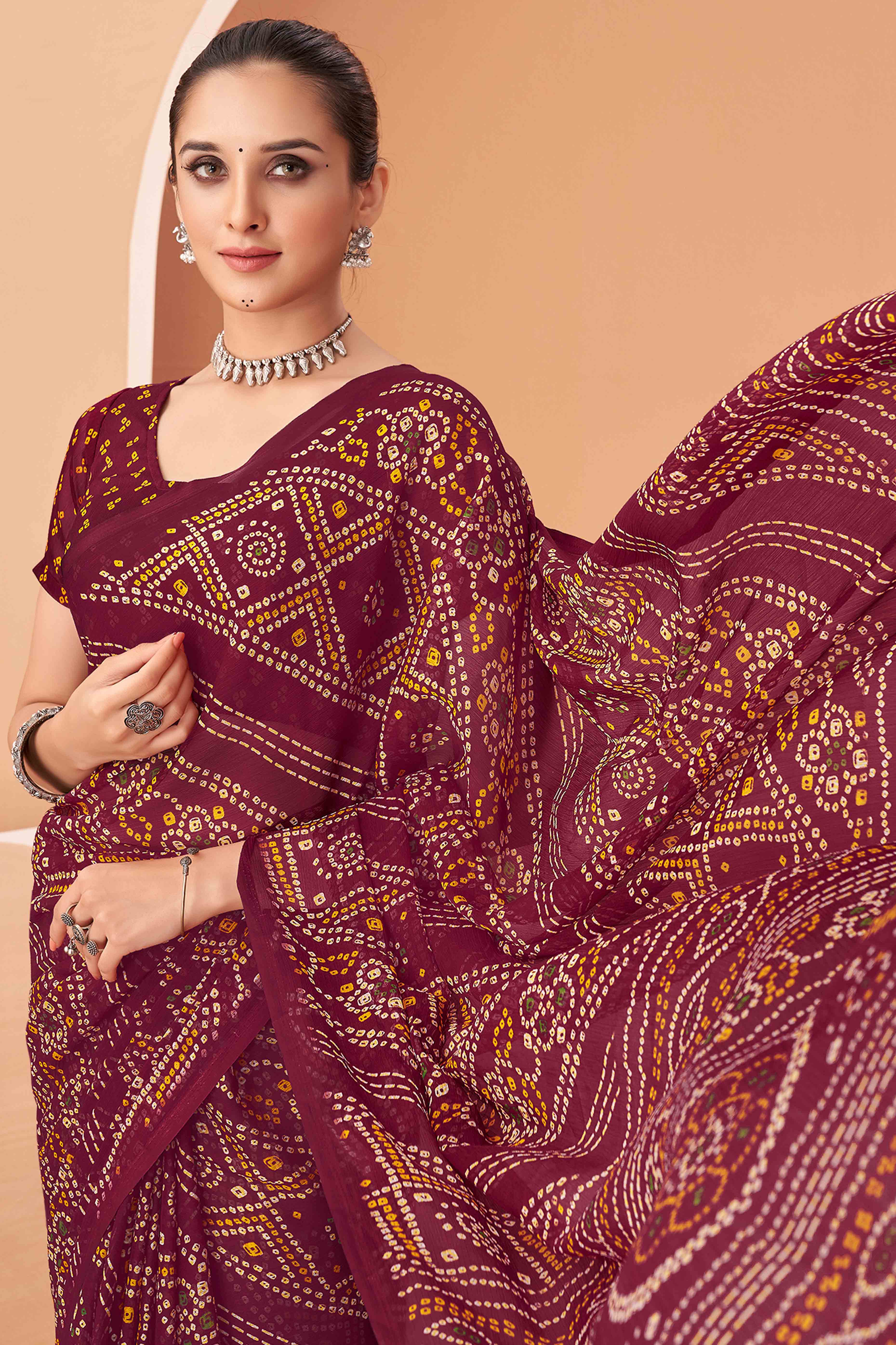 Maroon Bandhani Printed Chiffon Saree Accented With Intricate Lace Border Work