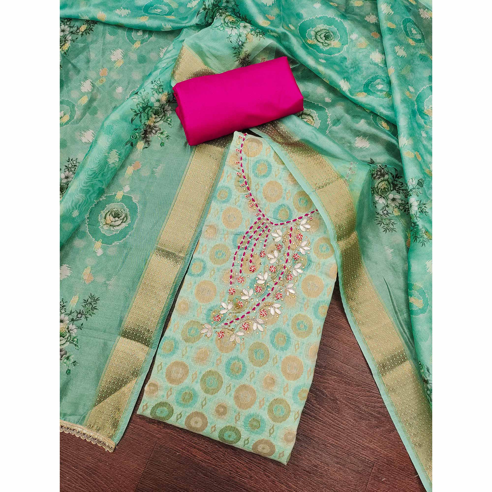 Sophisticated Turquoise Zari Woven Jacquard Dress Material Highlighted With Floral Handwork