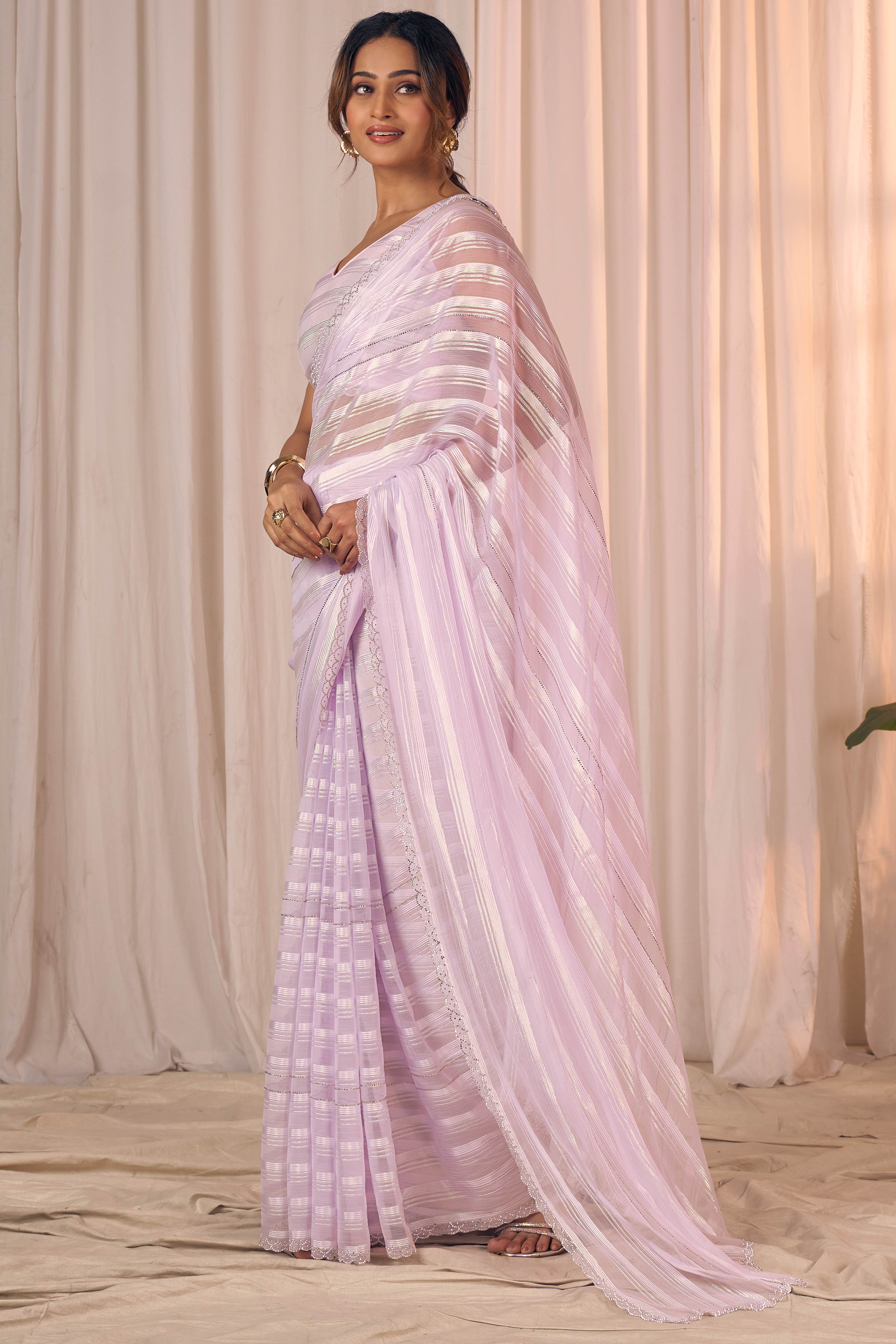Light Lavender Striped Georgette Saree With Sparkling Zarkan Work & An Elegant Cutwork Border