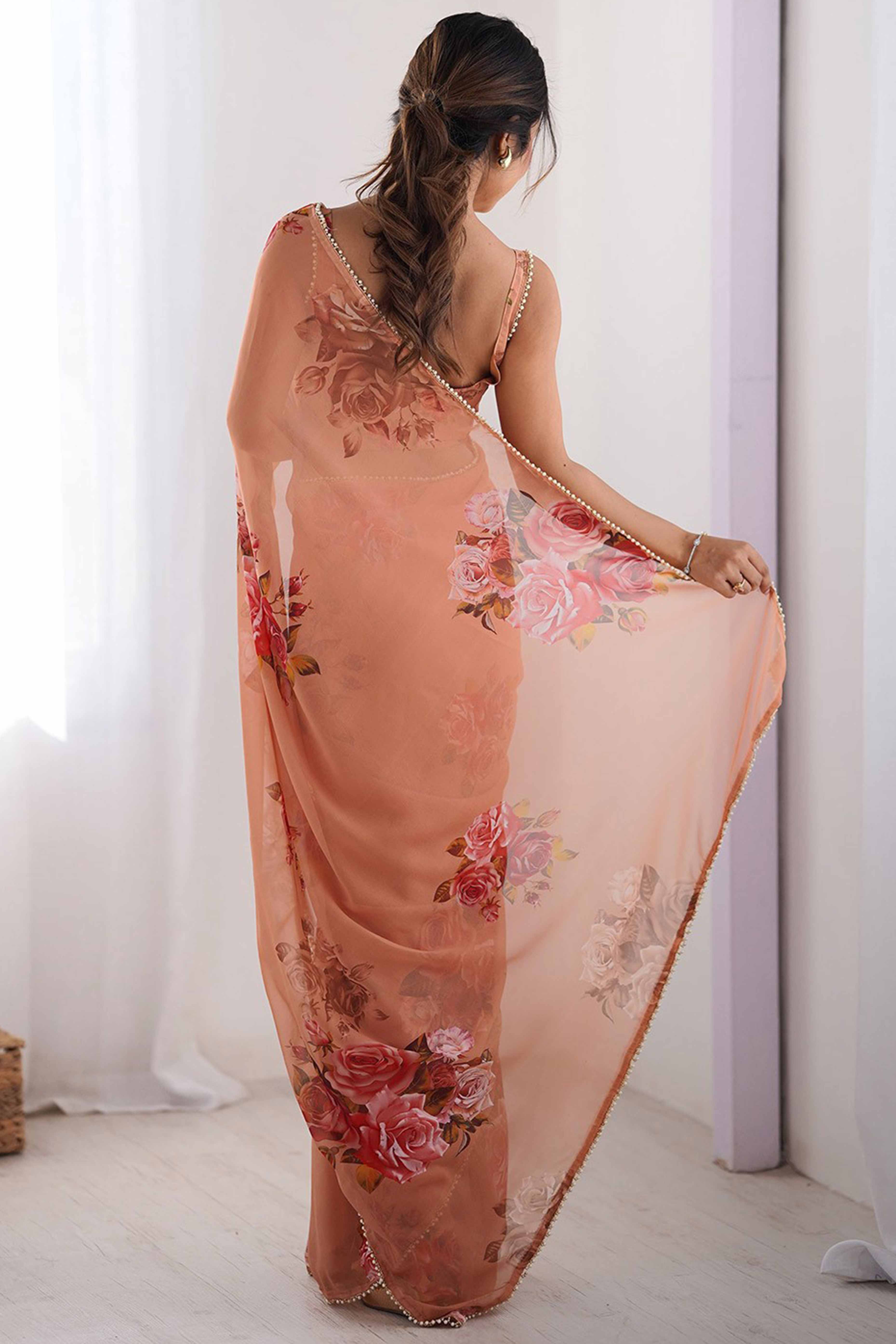 Partywear Peach Georgette Saree with Floral Prints and Bead Work Lace