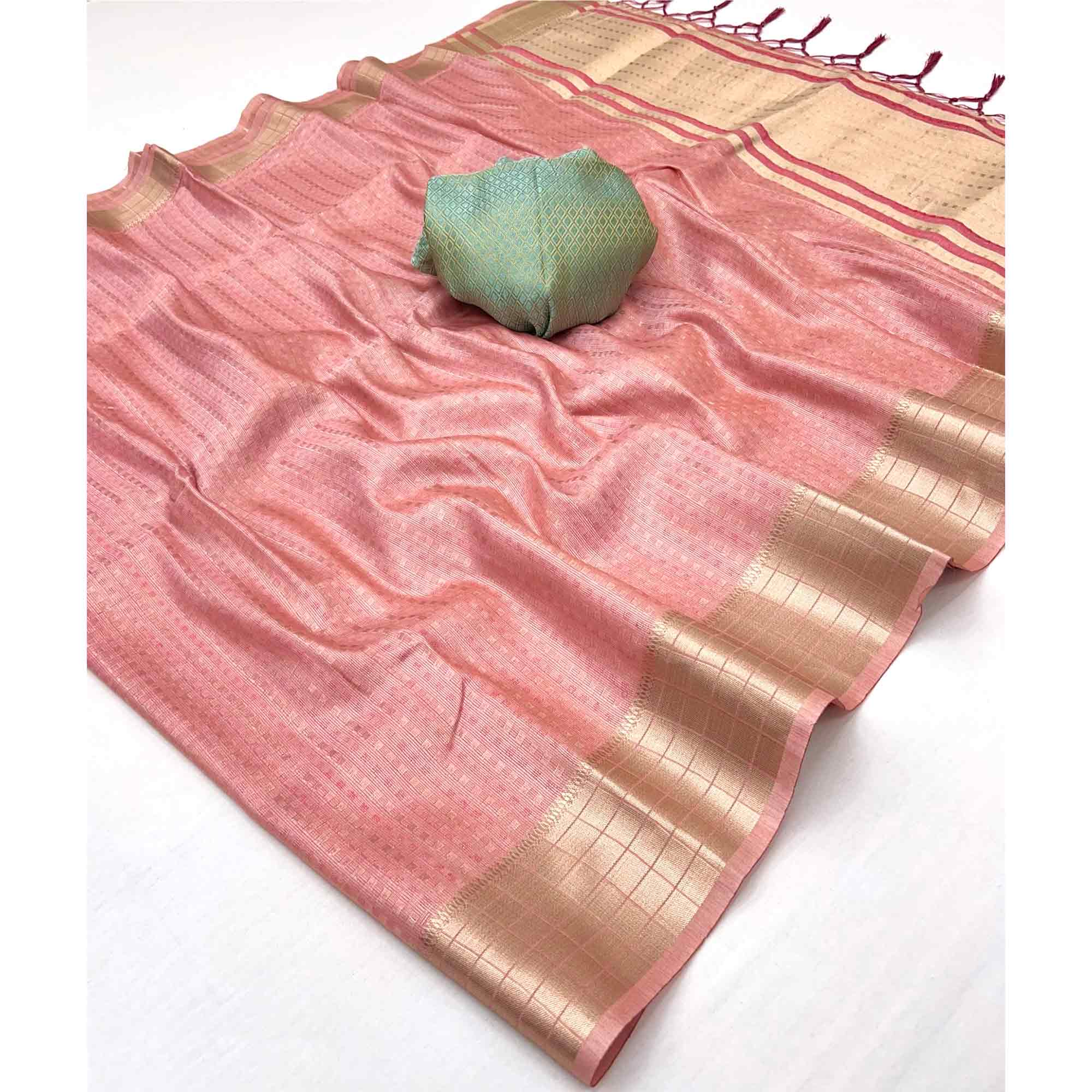 Peach Soft Tissue Saree Featuring Rich Zari Woven Detailing.