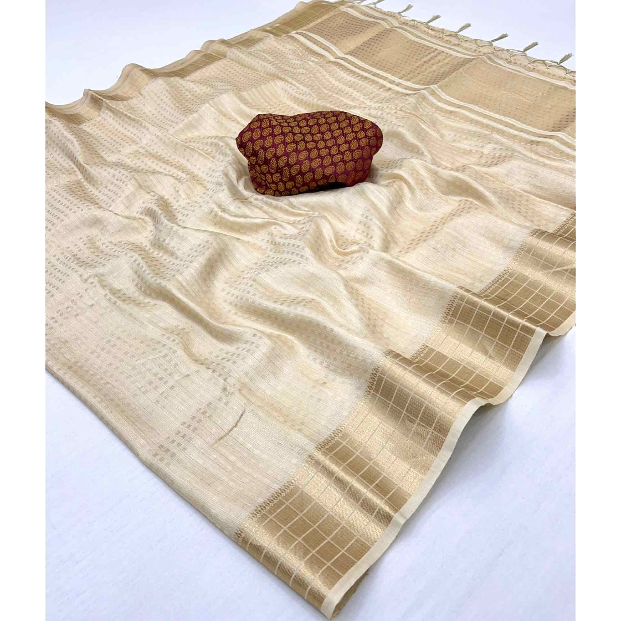 Cream Soft Tissue Saree Featuring Rich Zari-Woven Detailing.