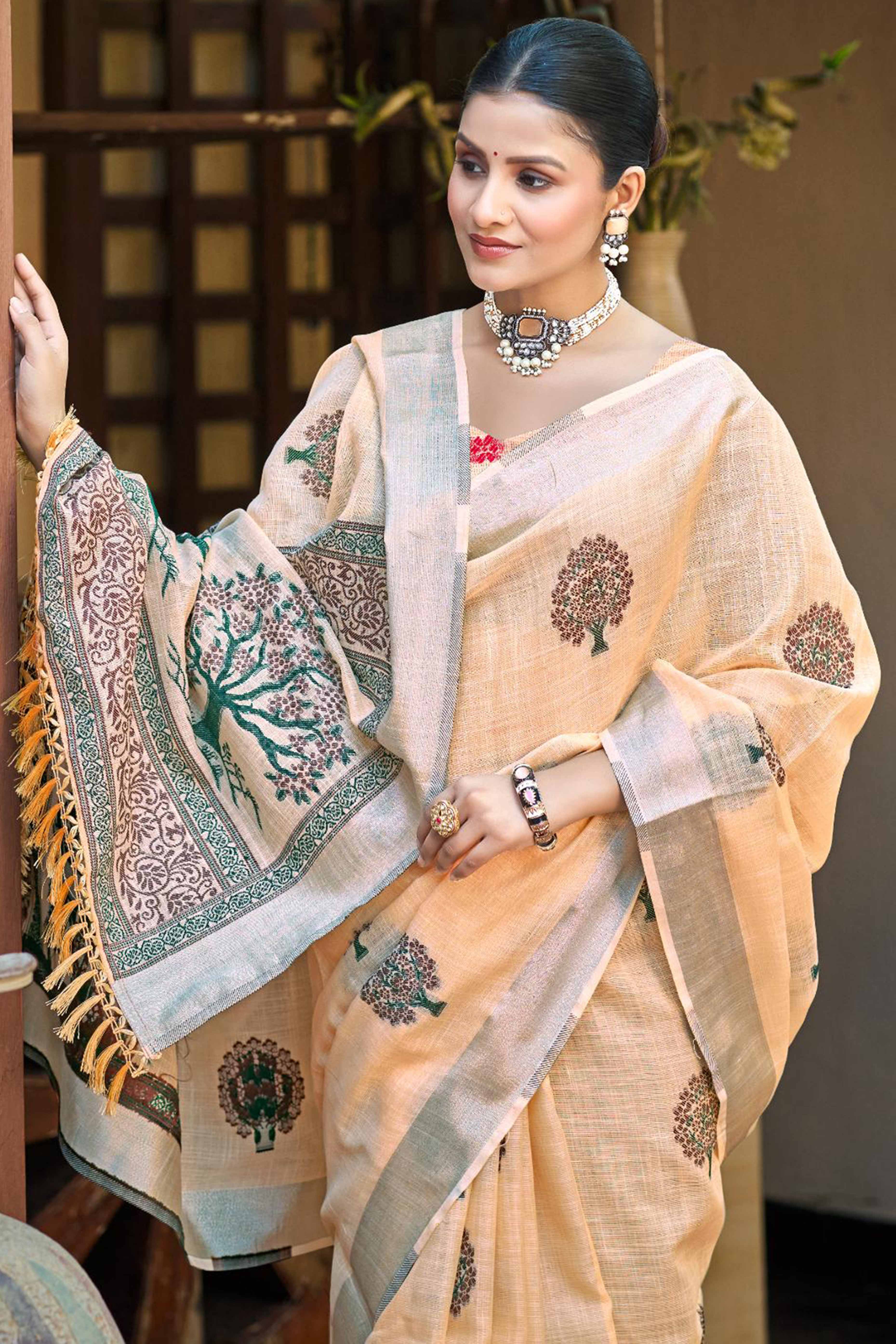 Peach Linen Saree Adorned With Intricate Zari Weaving & Tassel Pallu