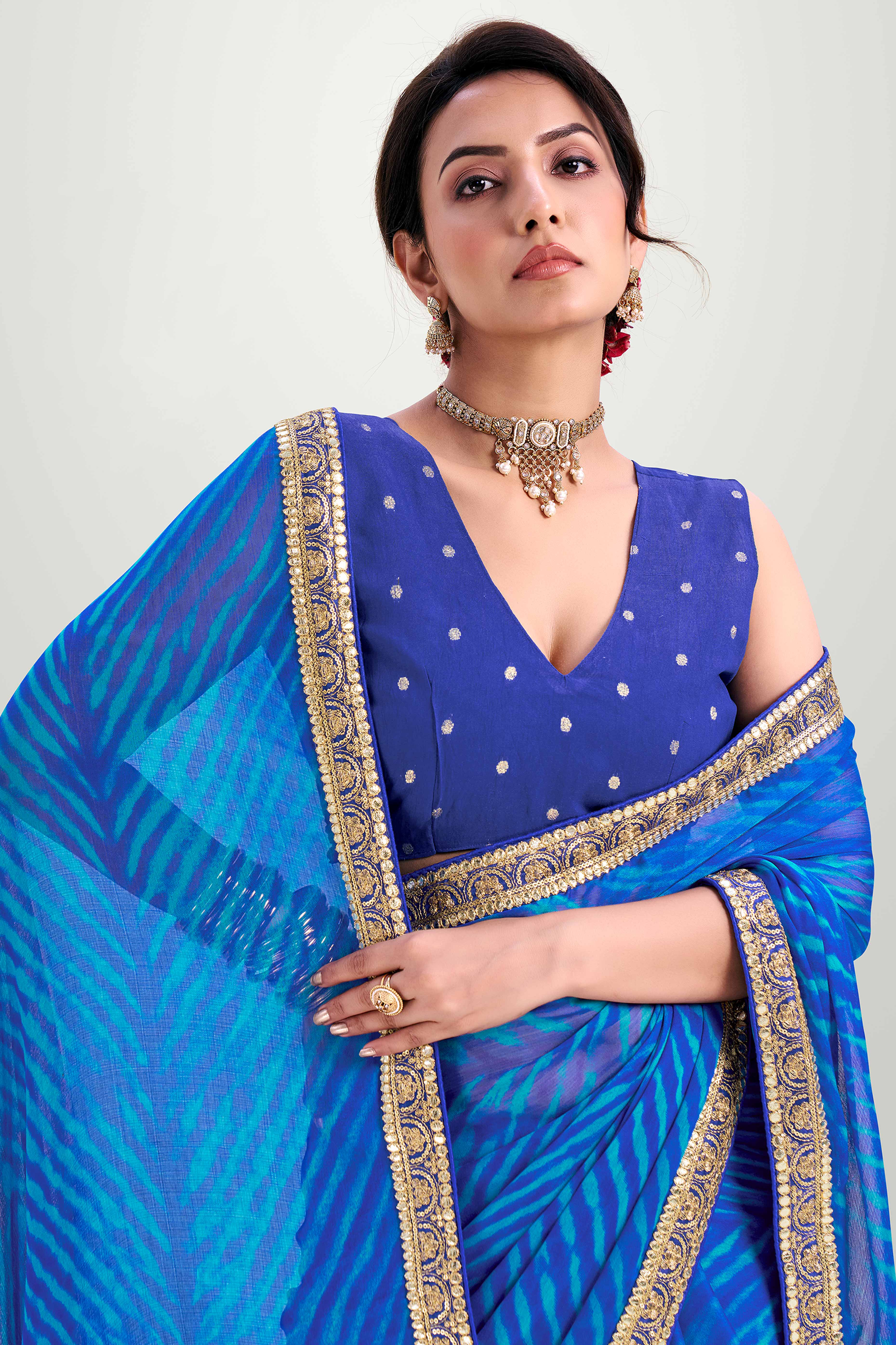 Blue Striped Printed Chiffon Saree Enhanced With Sparkling Sequins Embroidered Border Work