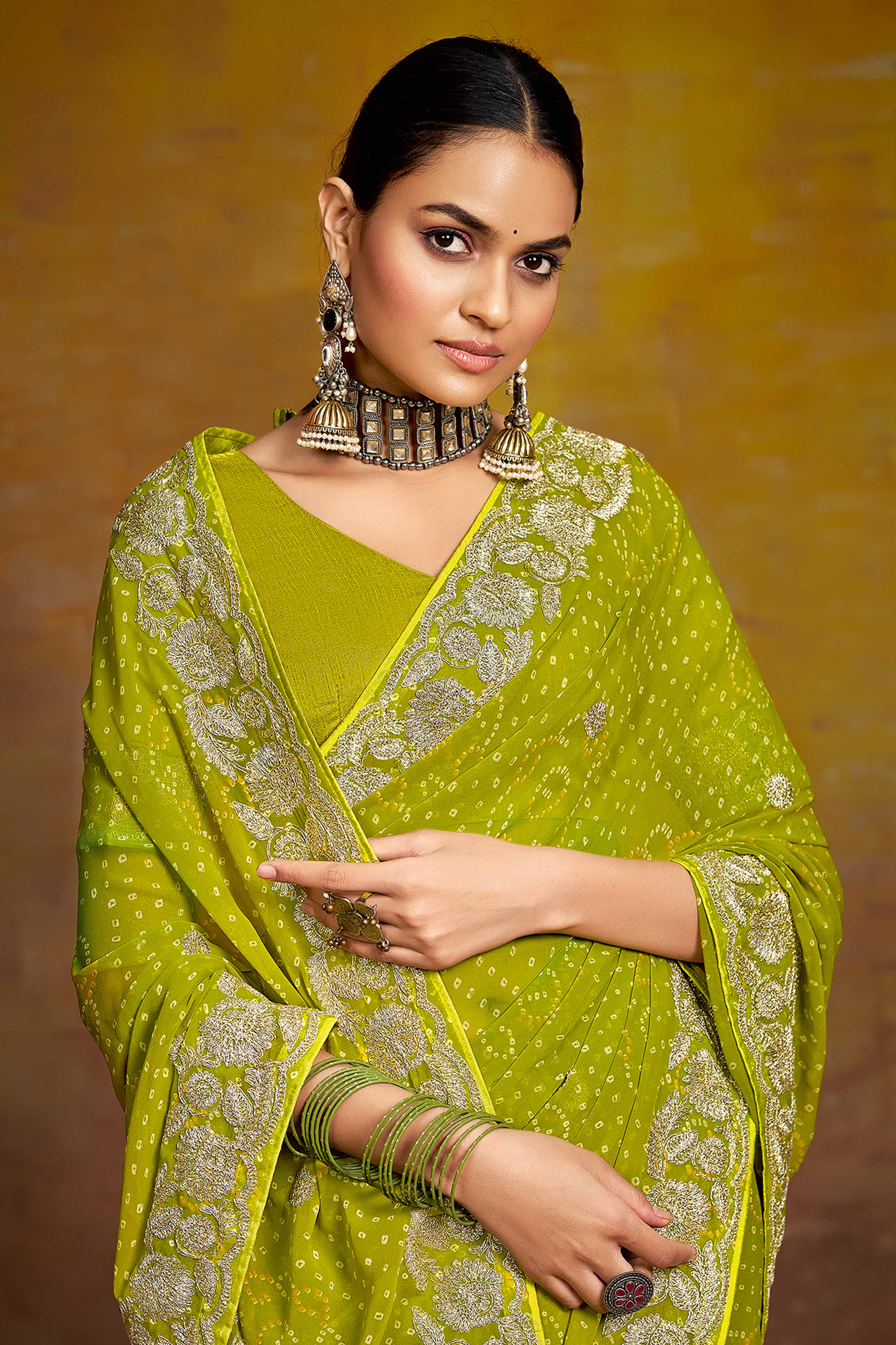 Green Georgette Saree Adorned With Traditional Bandhani Prints & Intricate Floral Embroidery