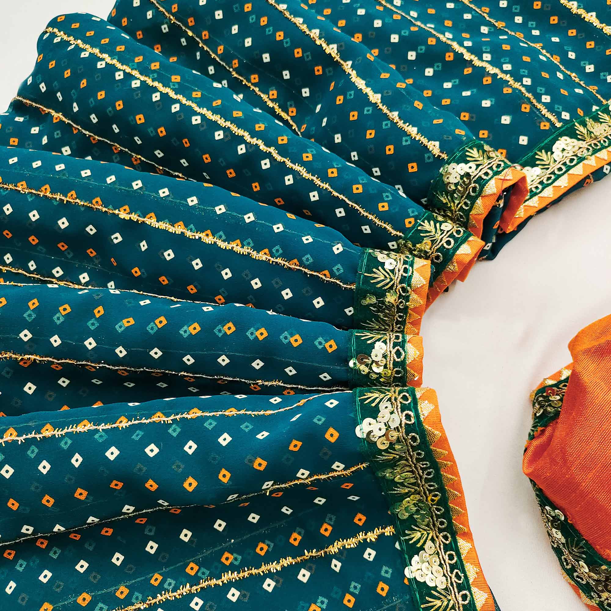 Charming Teal Bandhani Printed Georgette Saree With Glittering Sequins & Zari Border