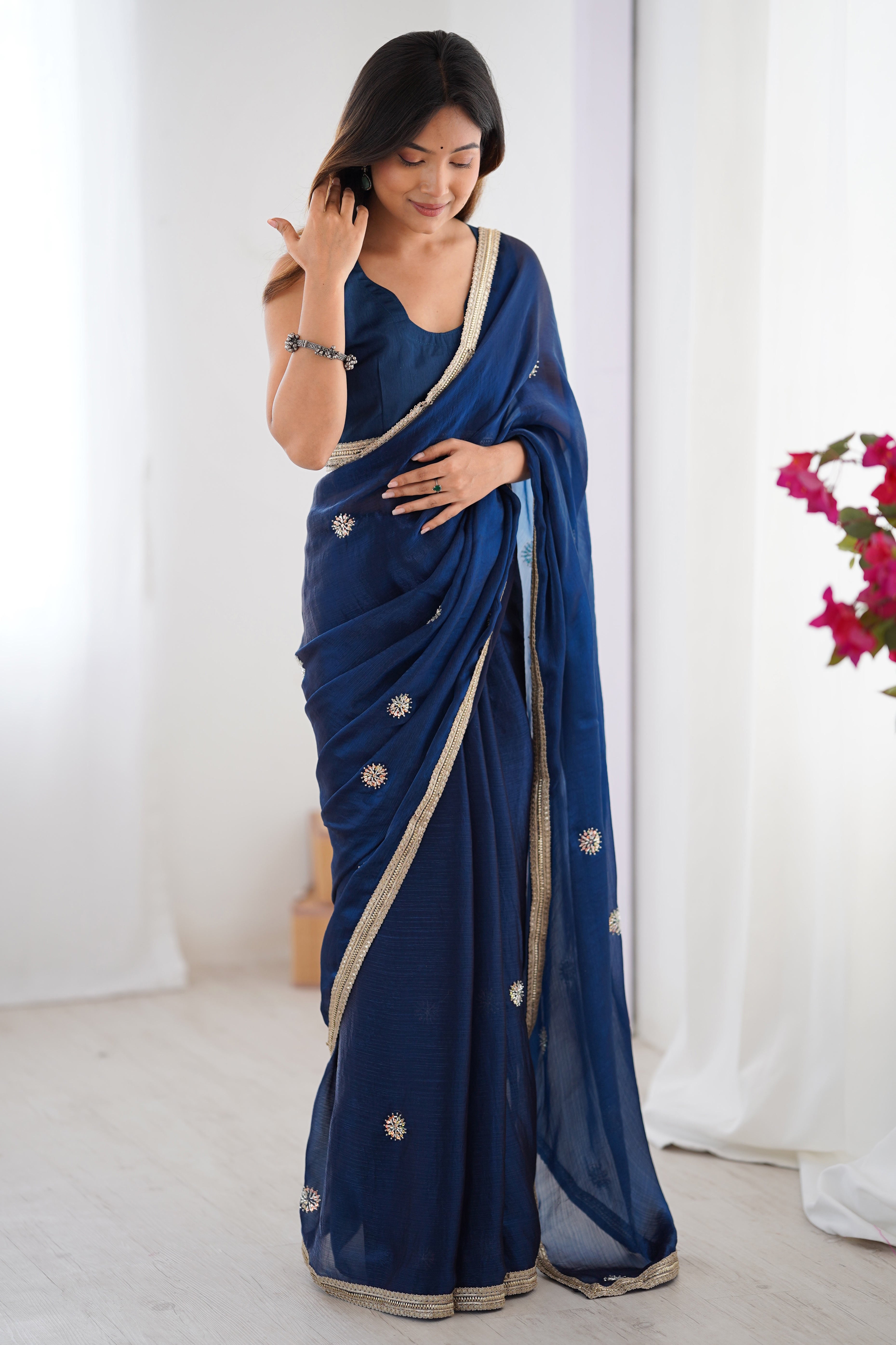 Elegant Blue Organza Saree with Delicate Floral Embellishments and Lace Border