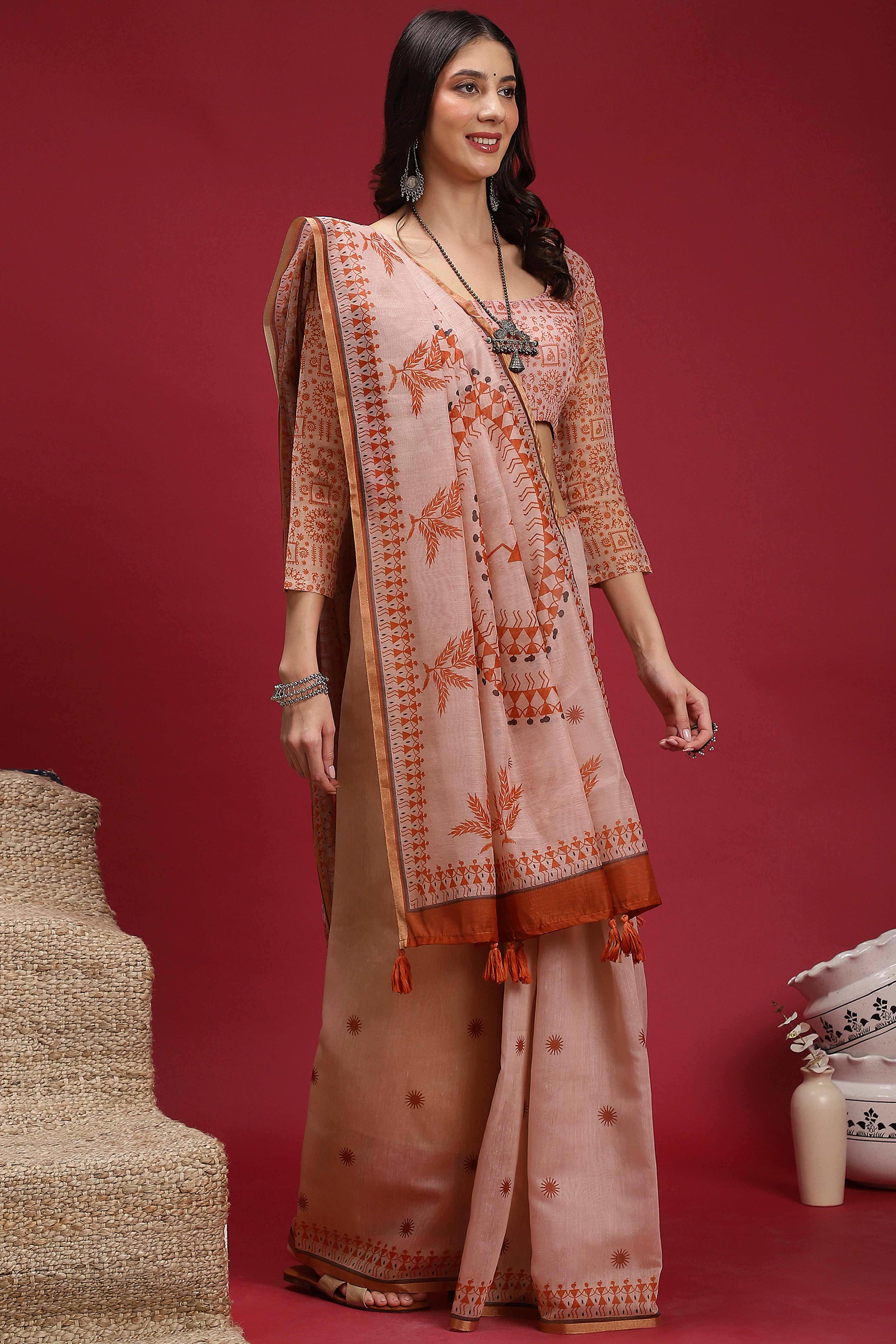 Light Peach Linen Cotton Saree Featuring Traditional Warli Prints & Tassel Pallu