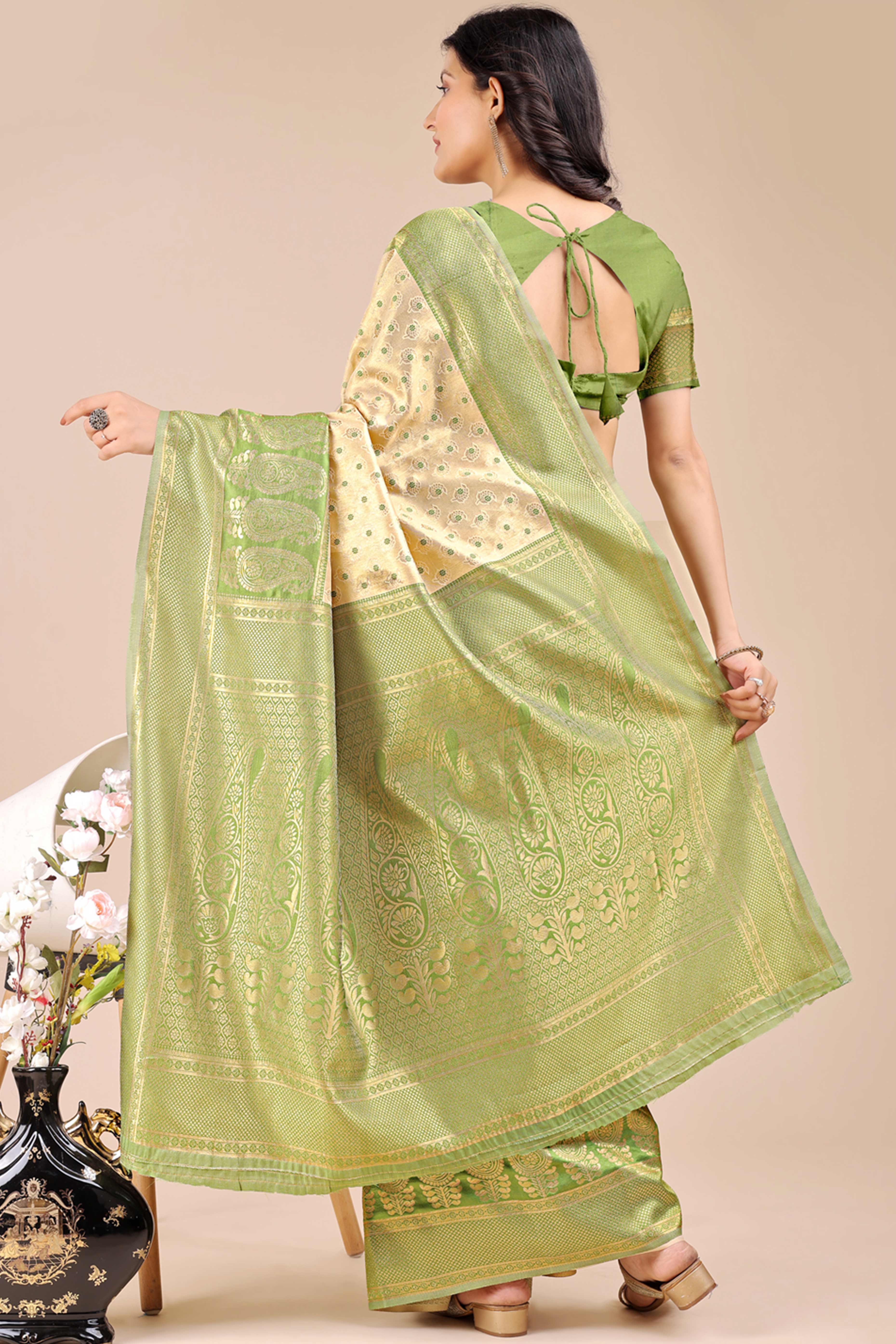 Cream Banarasi Silk Saree Featuring Lustrous Light Green Floral Zari Weaving and a Rich Contrast Border