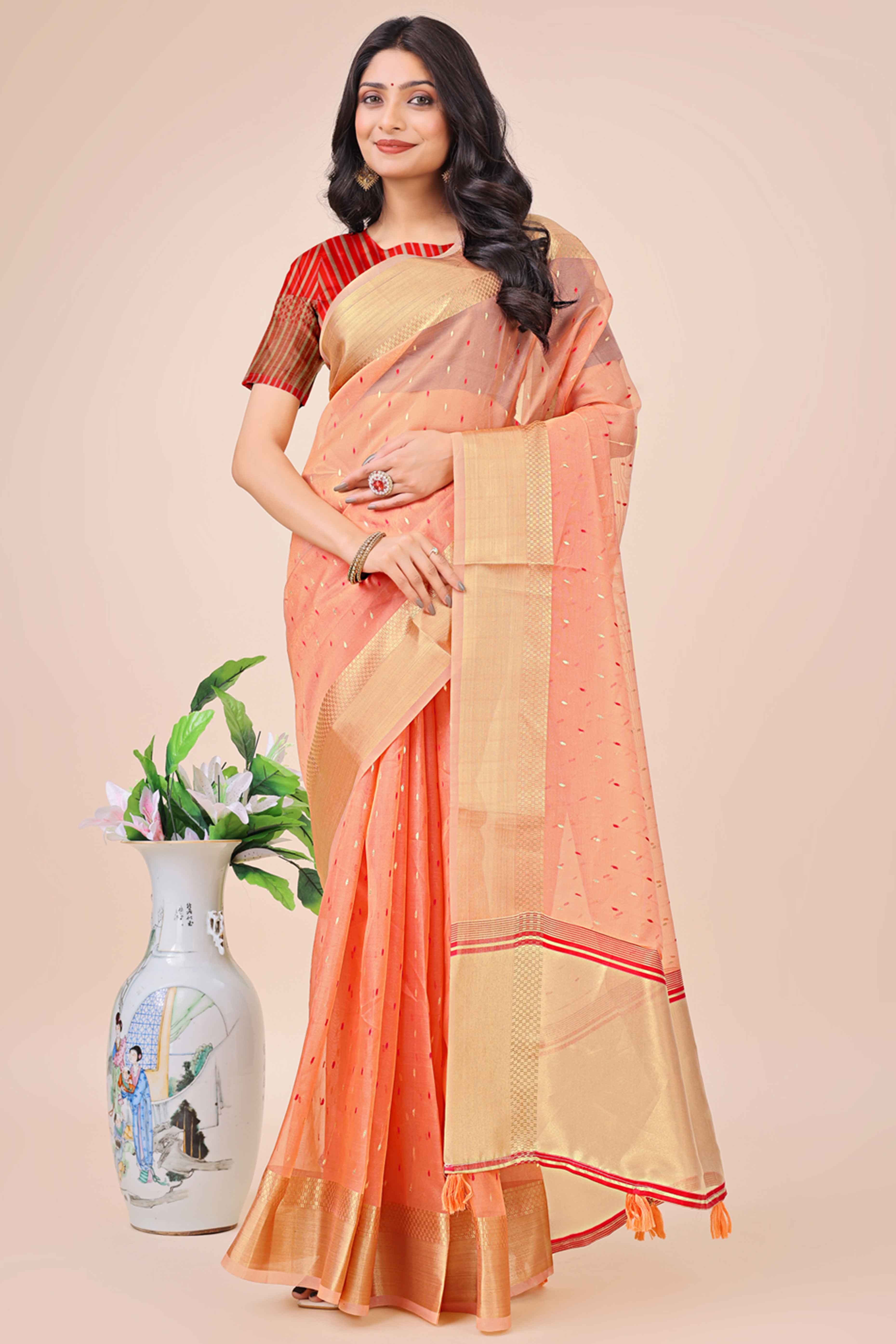 Peach Organza Saree Adorned With Fine Zari Weaving & Stylish Tassel Edging