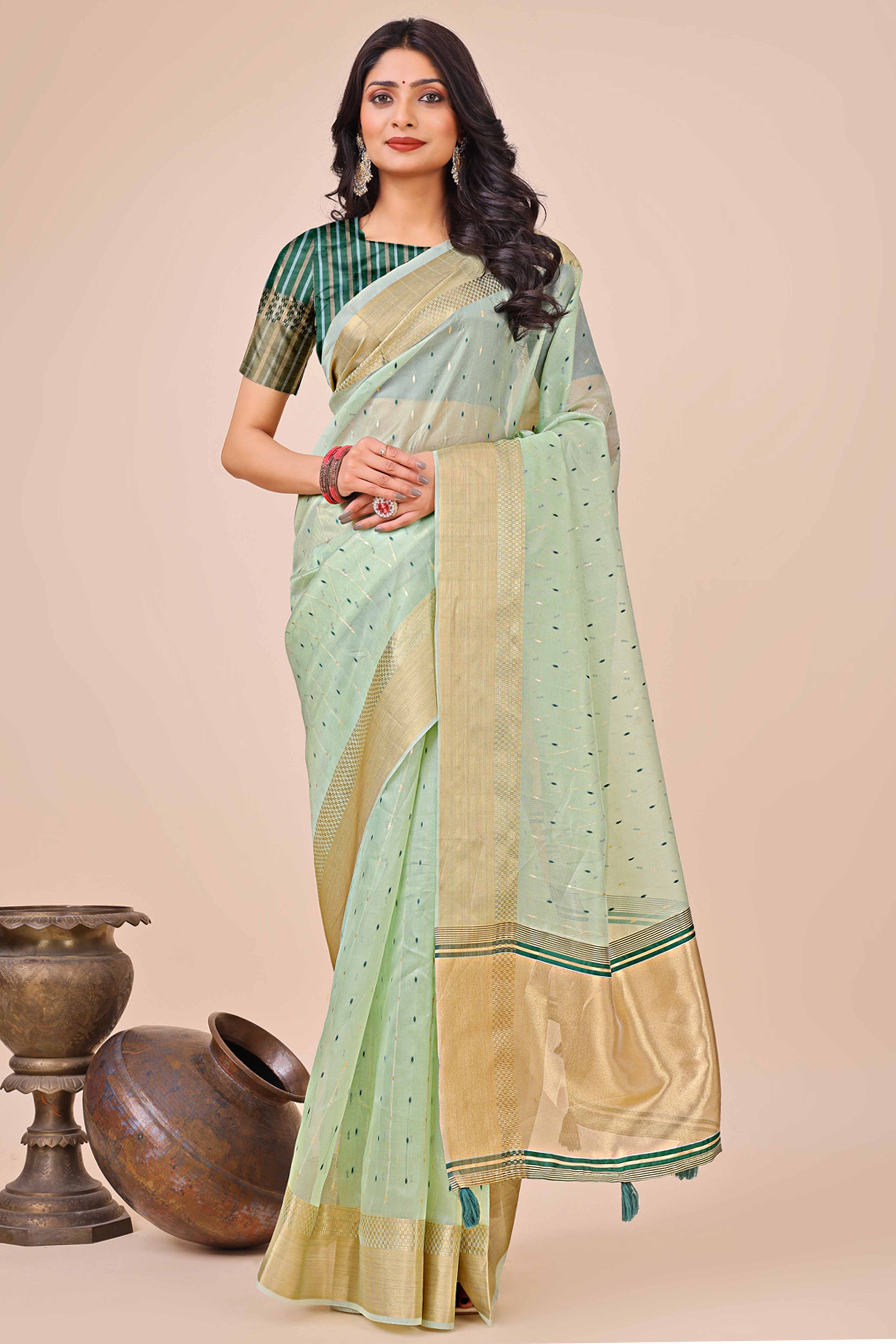 Sea Green Organza Saree Adorned With Fine Zari Weaving & Stylish Tassel Edging