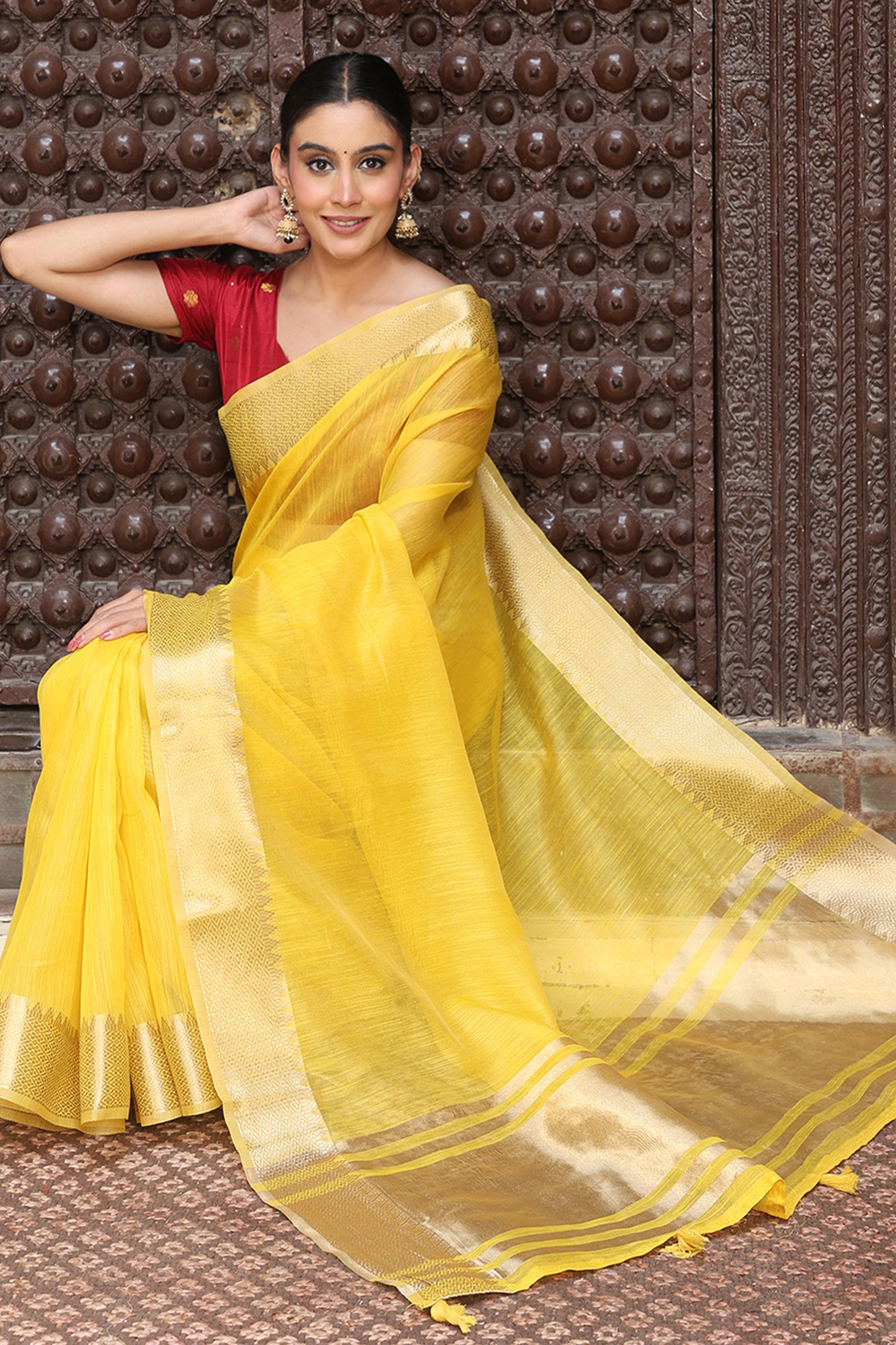 Trendy Yellow Cotton Blend Saree Showcasing Elegant Zari Weaving & Tassel Border Pallu