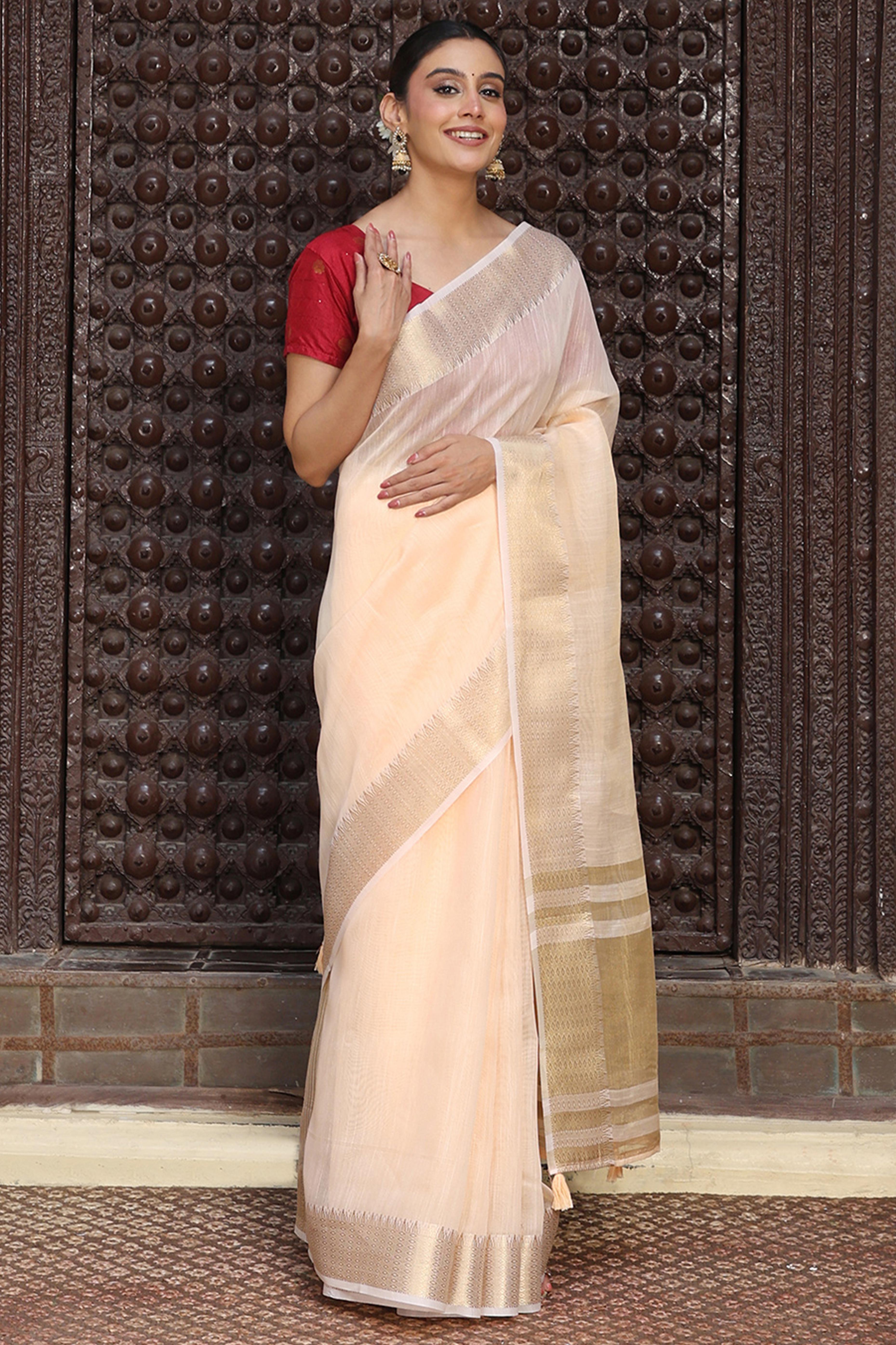 Charming Peach Zari Weaving Cotton Blend Saree Adorned With Stylish Tassel Detailing