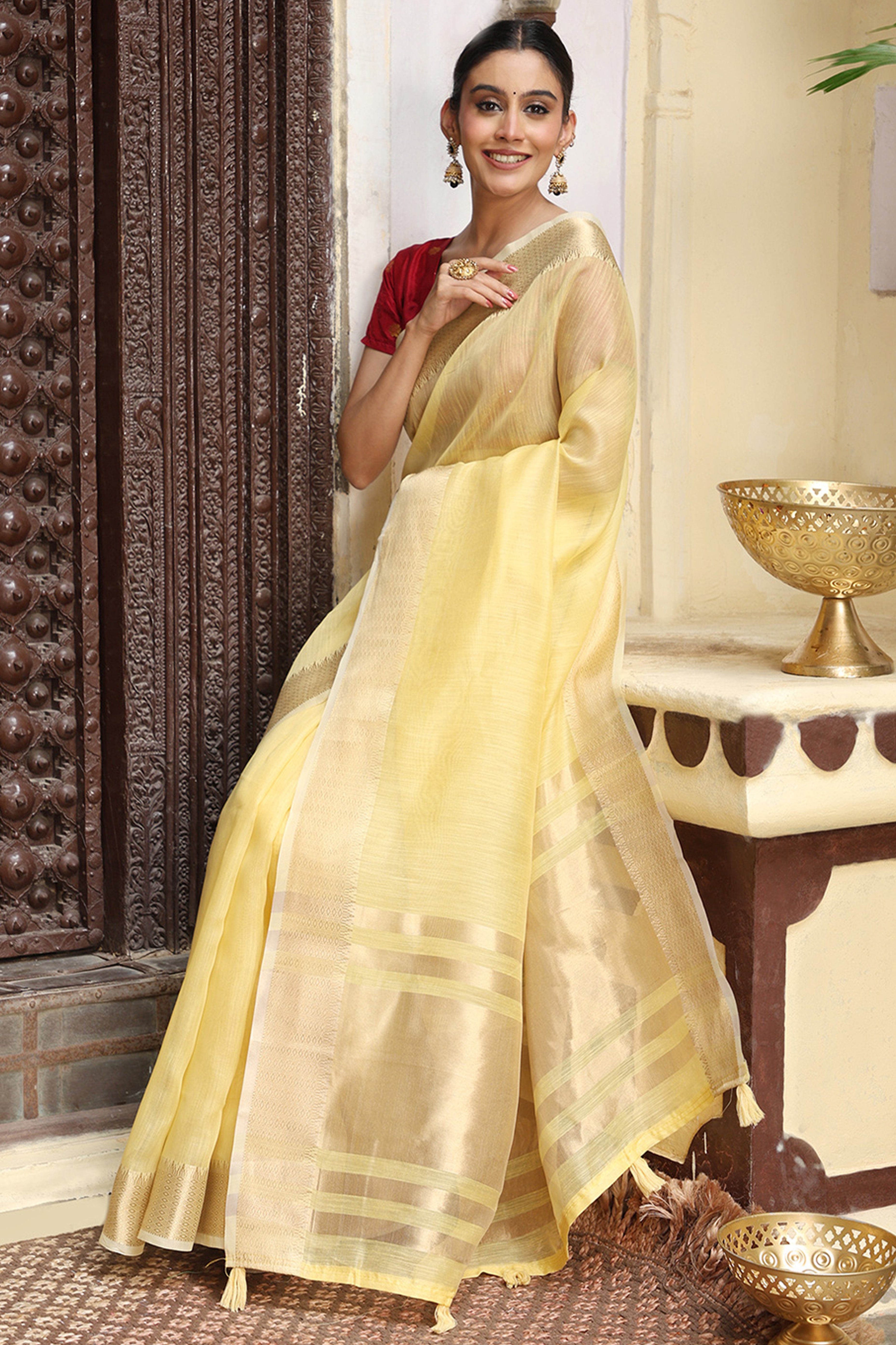 Charming Yellow Zari Weaving Cotton Blend Saree Adorned With Stylish Tassel Detailing
