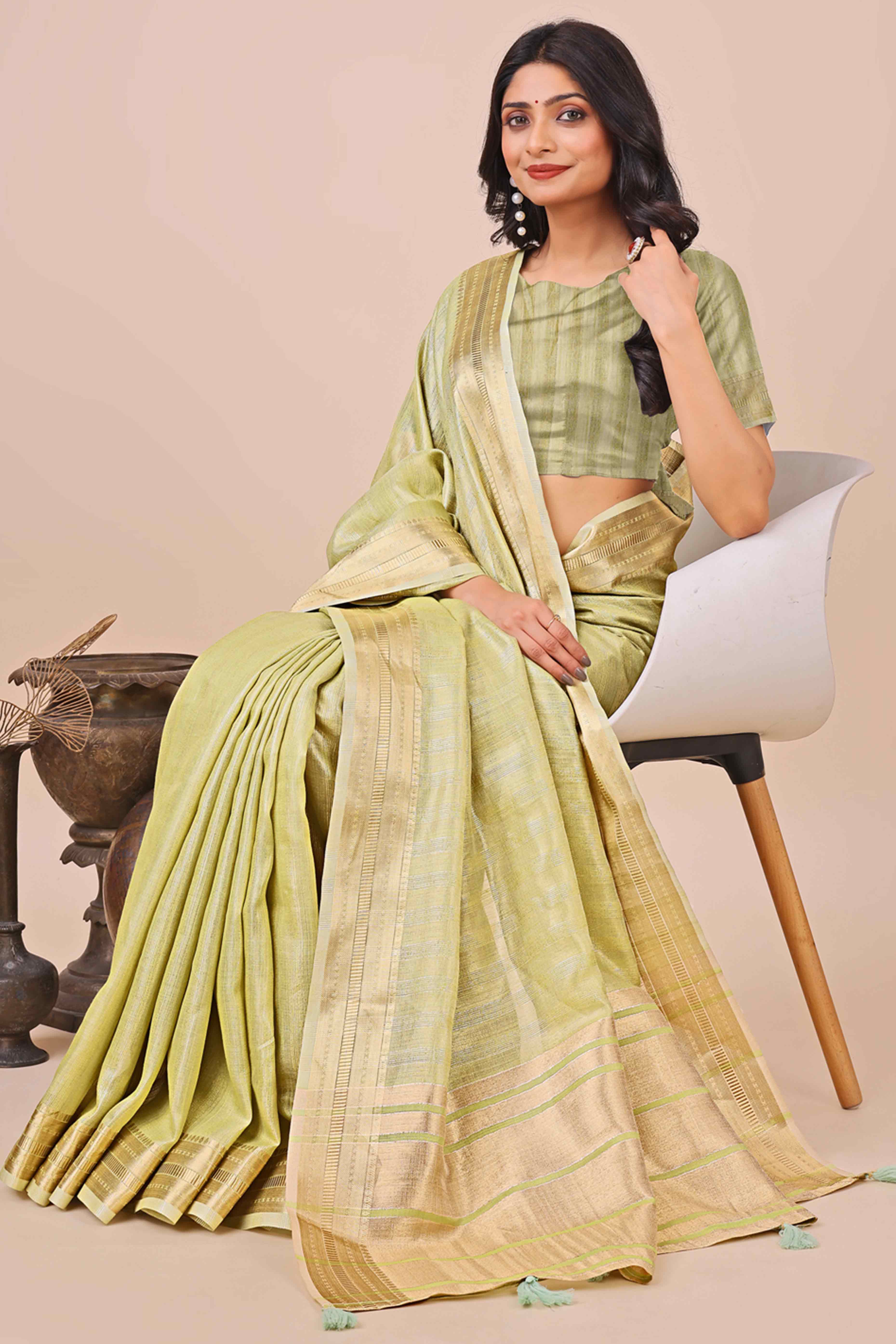 Light Green Organza Saree With Intricate Weave & Elegant Tassel Accents