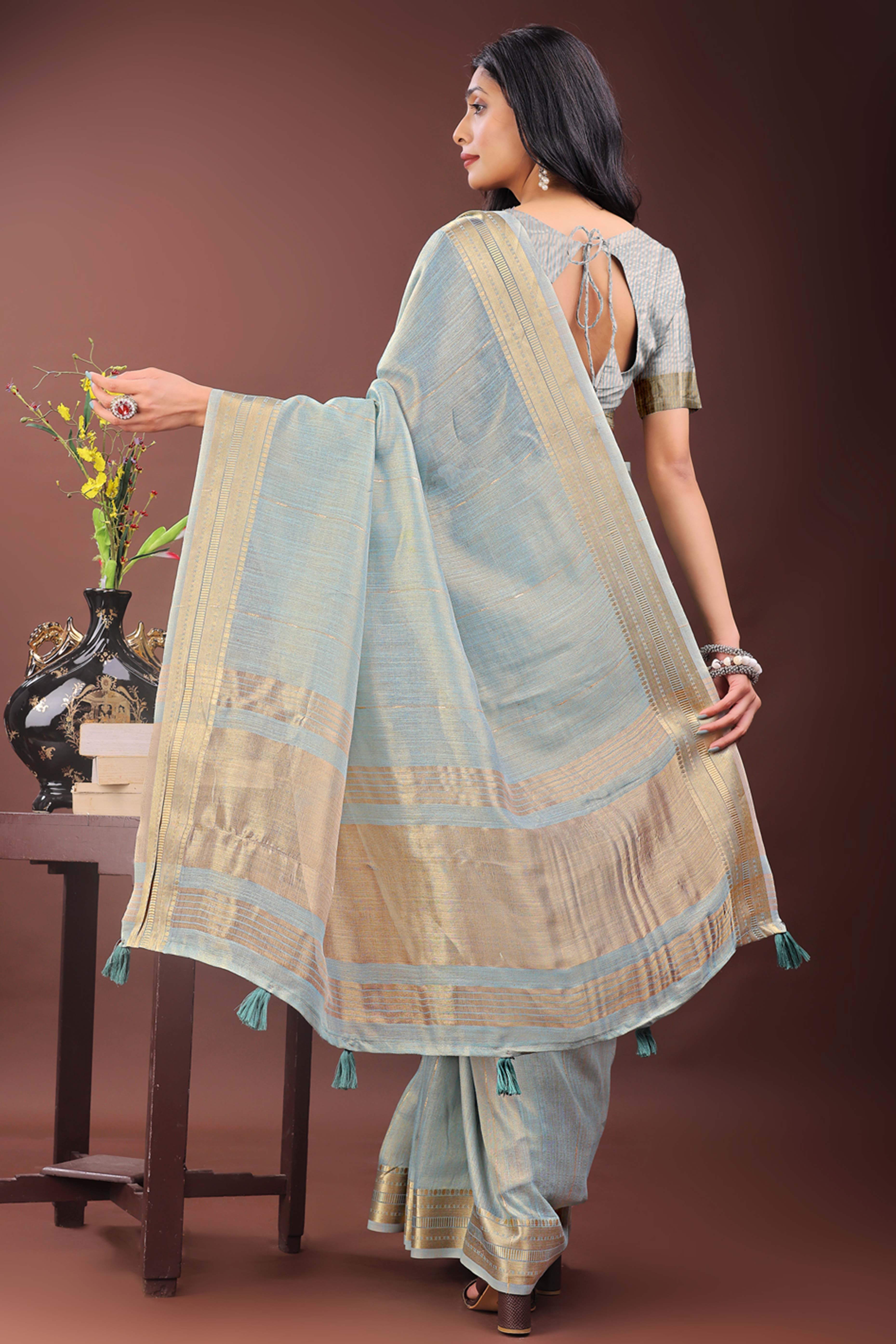 Greyish Blue Organza Saree Adorned With Zari Weave & Tassel Edges