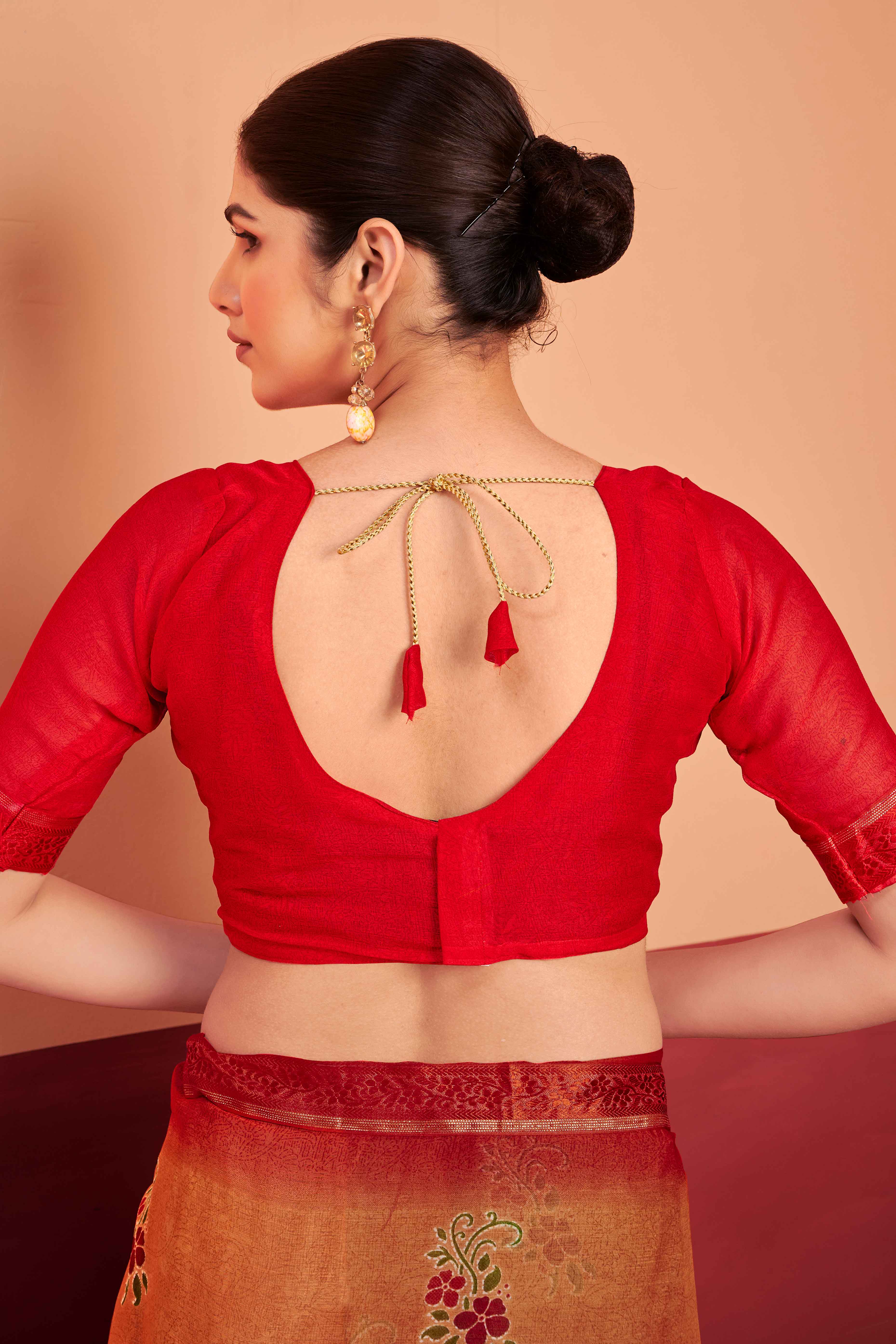 Orange Chiffon Saree Featuring Delicate Floral Prints & A Graceful Lace Border