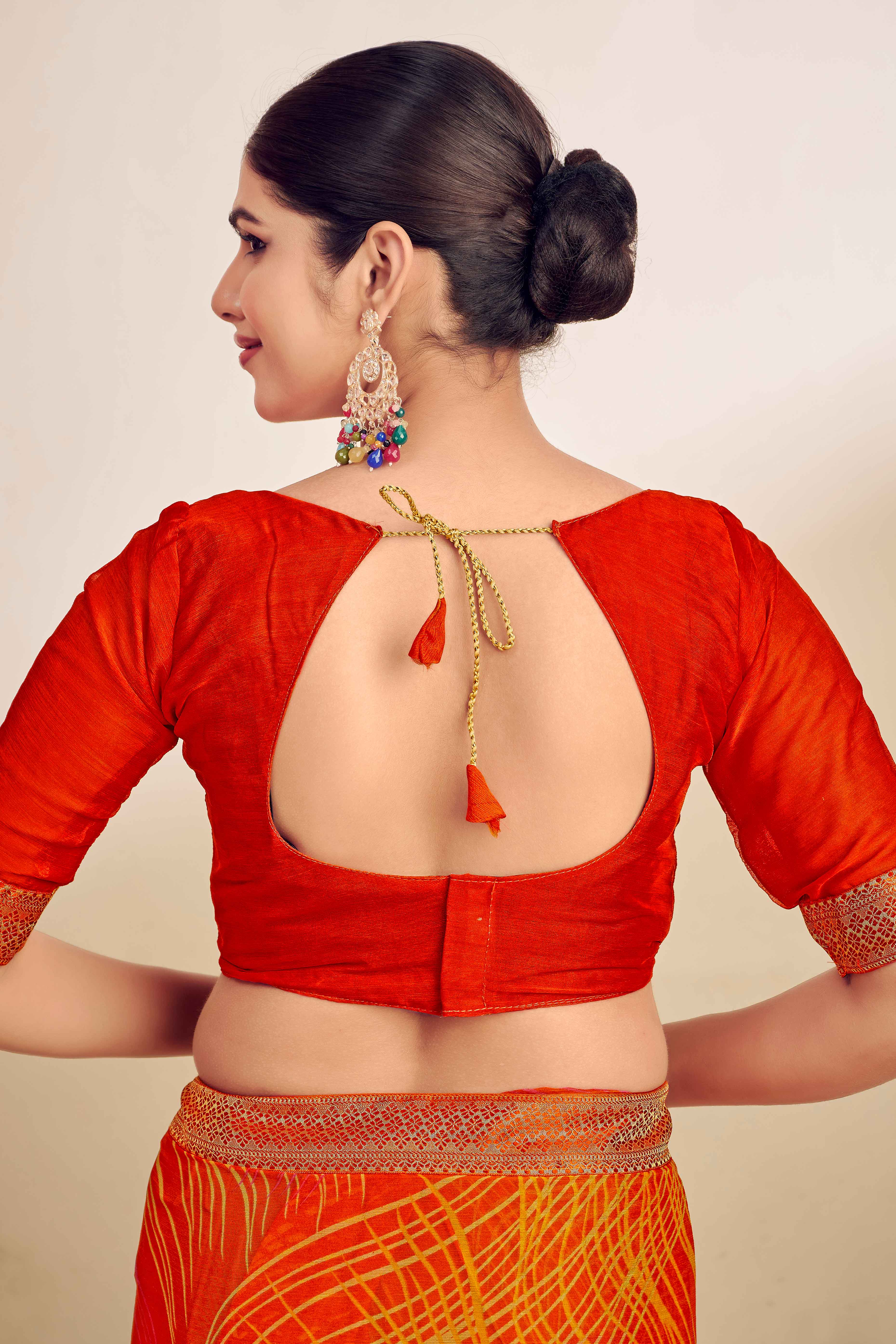 Orange Chiffon Saree Adorned With Artistic Print & Finely Crafted Woven Lace Border