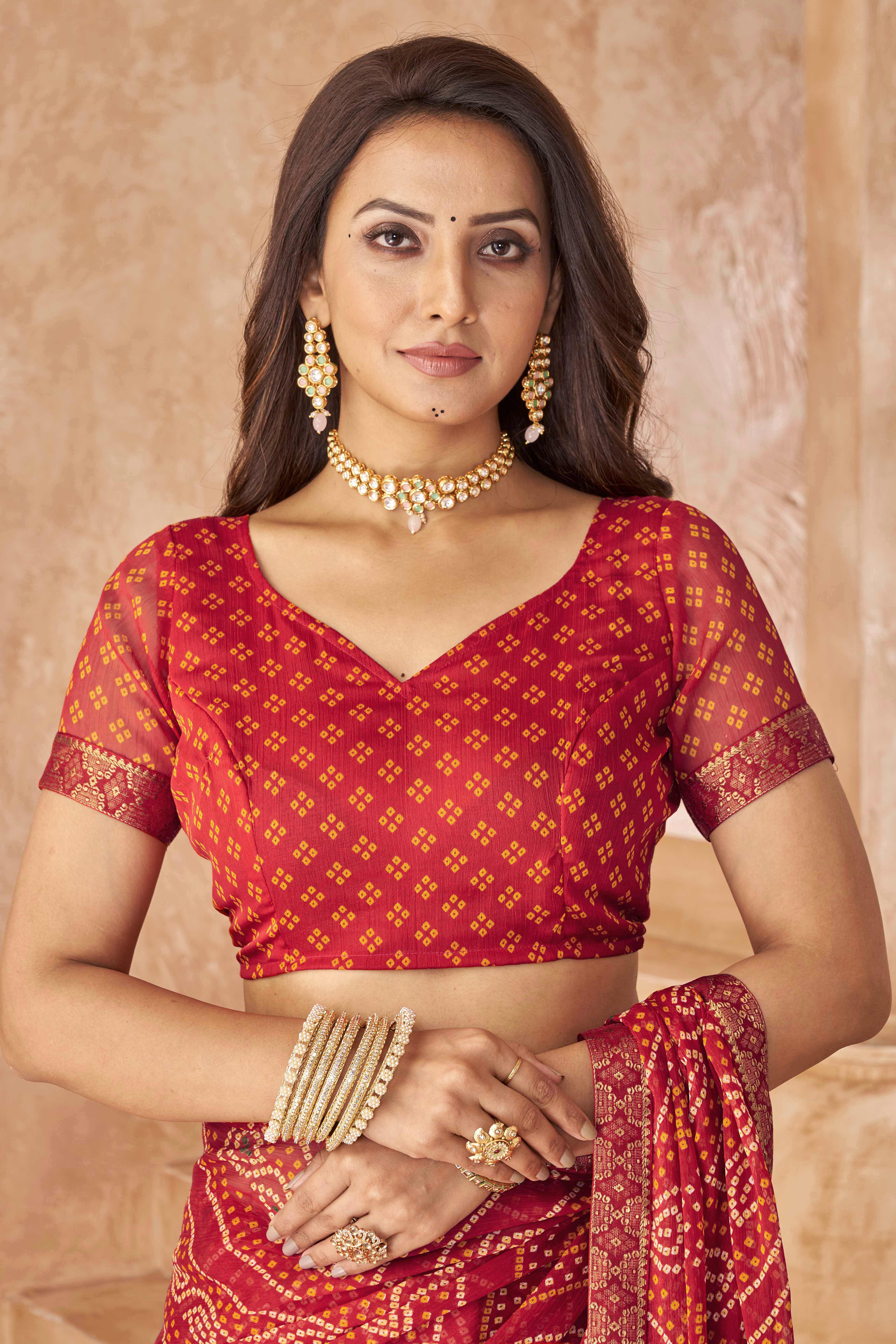 Red Chiffon Saree Featuring Traditional Bandhani Prints & A Graceful Lace Edge