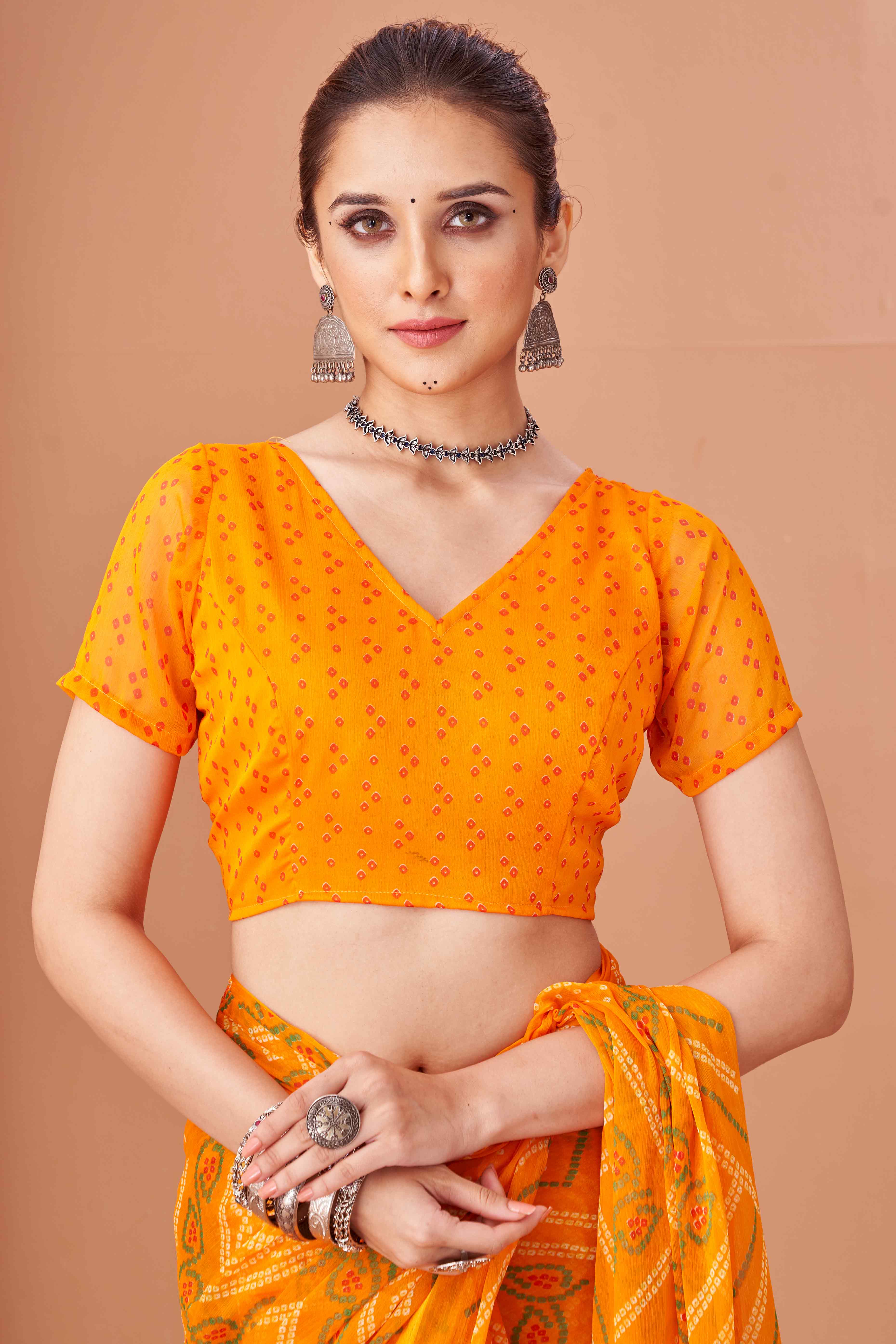 Mustard Bandhani Printed Chiffon Saree Accented With Intricate Lace Border Work