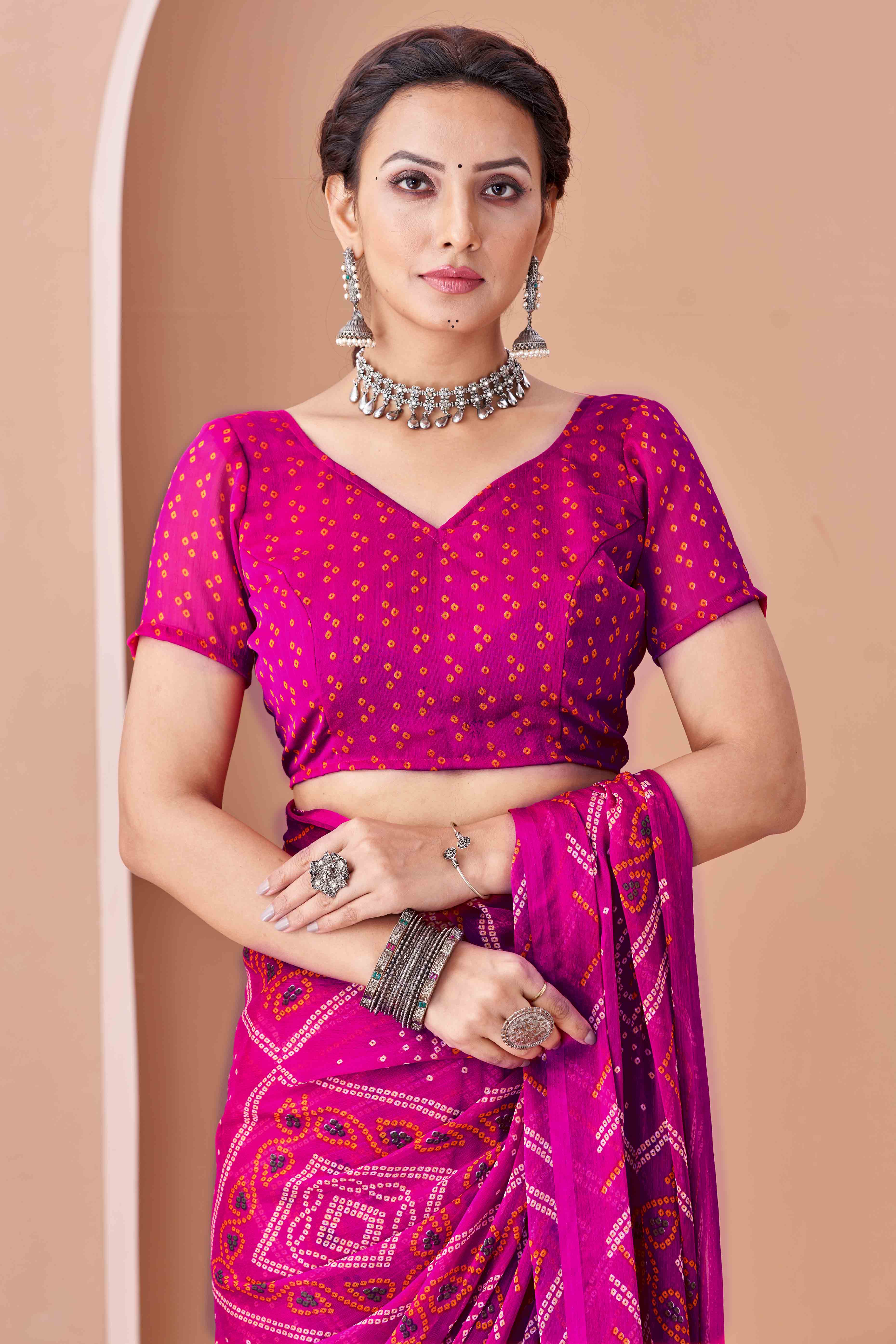Magenta Bandhani Printed Chiffon Saree Accented With Intricate Lace Border Work