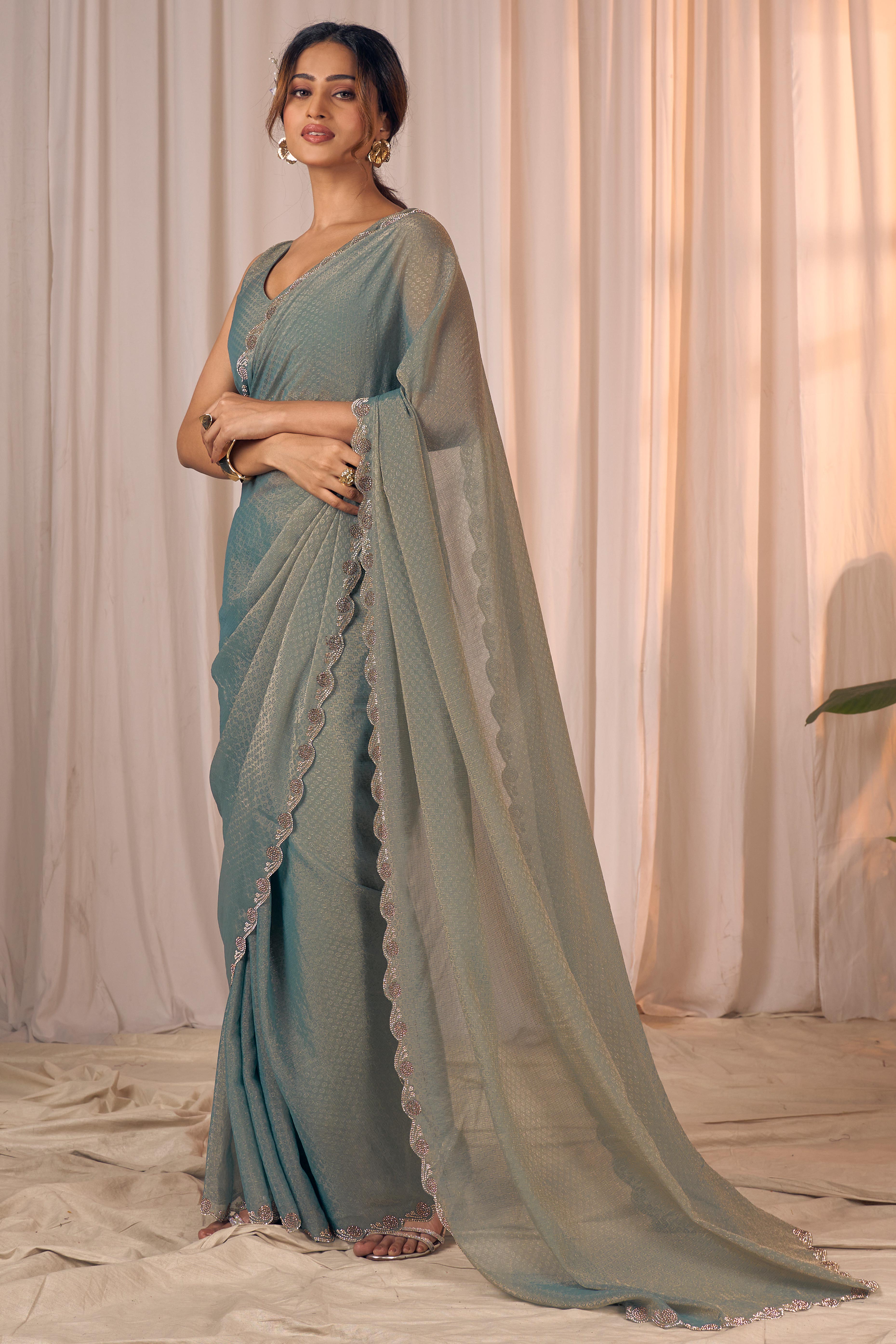 Designer Sage Green Georgette Saree Adorned With An Elegant Zarkan Cutwork Border