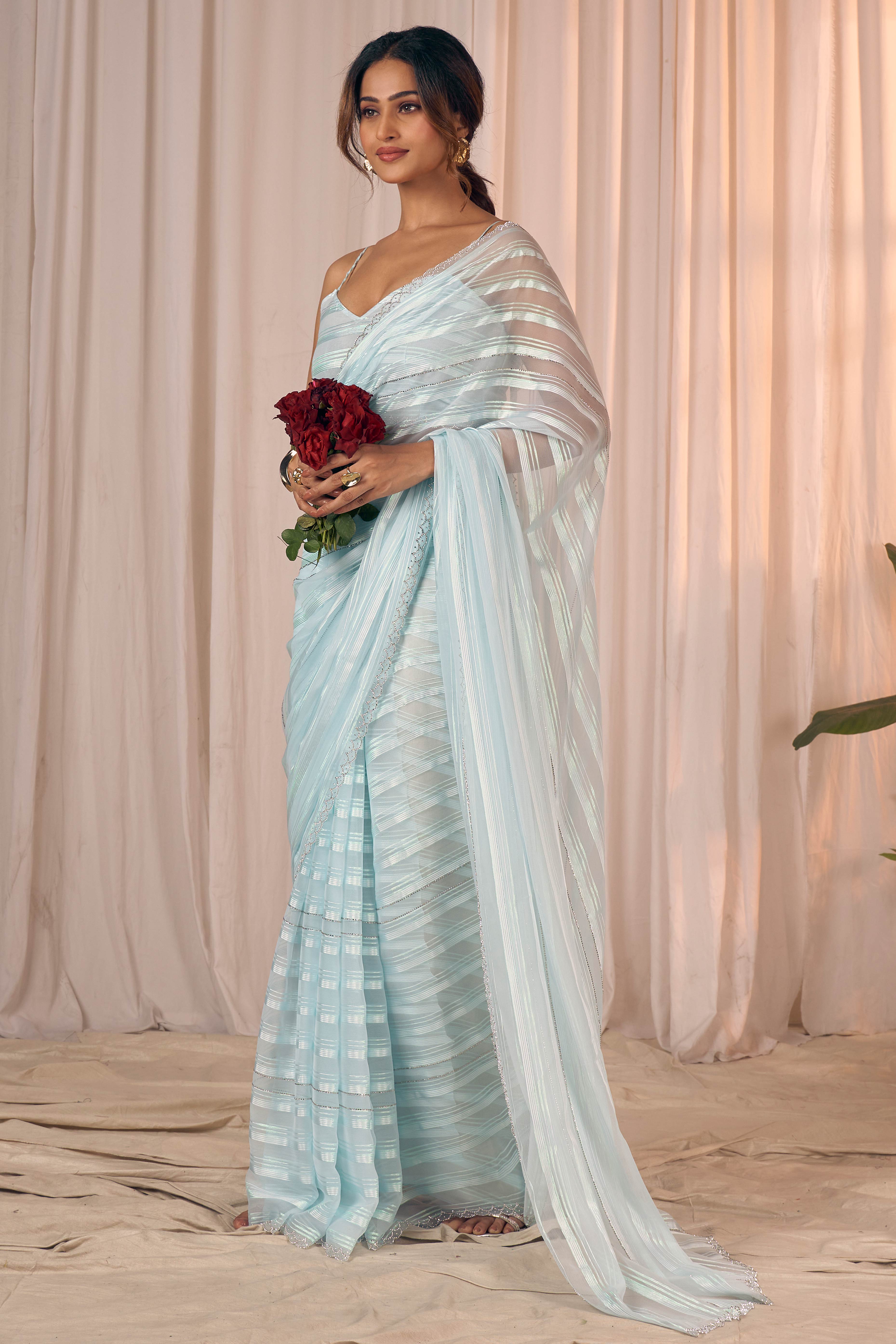 Light Turquoise Striped Georgette Saree With Sparkling Zarkan Work & An Elegant Cutwork Border