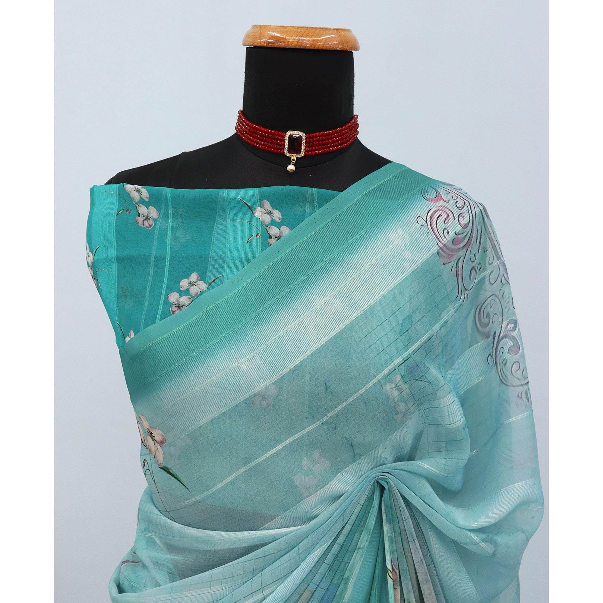Charming Turquoise Blue Floral Digital Printed Georgette Saree Accentuated With Zari Stripes