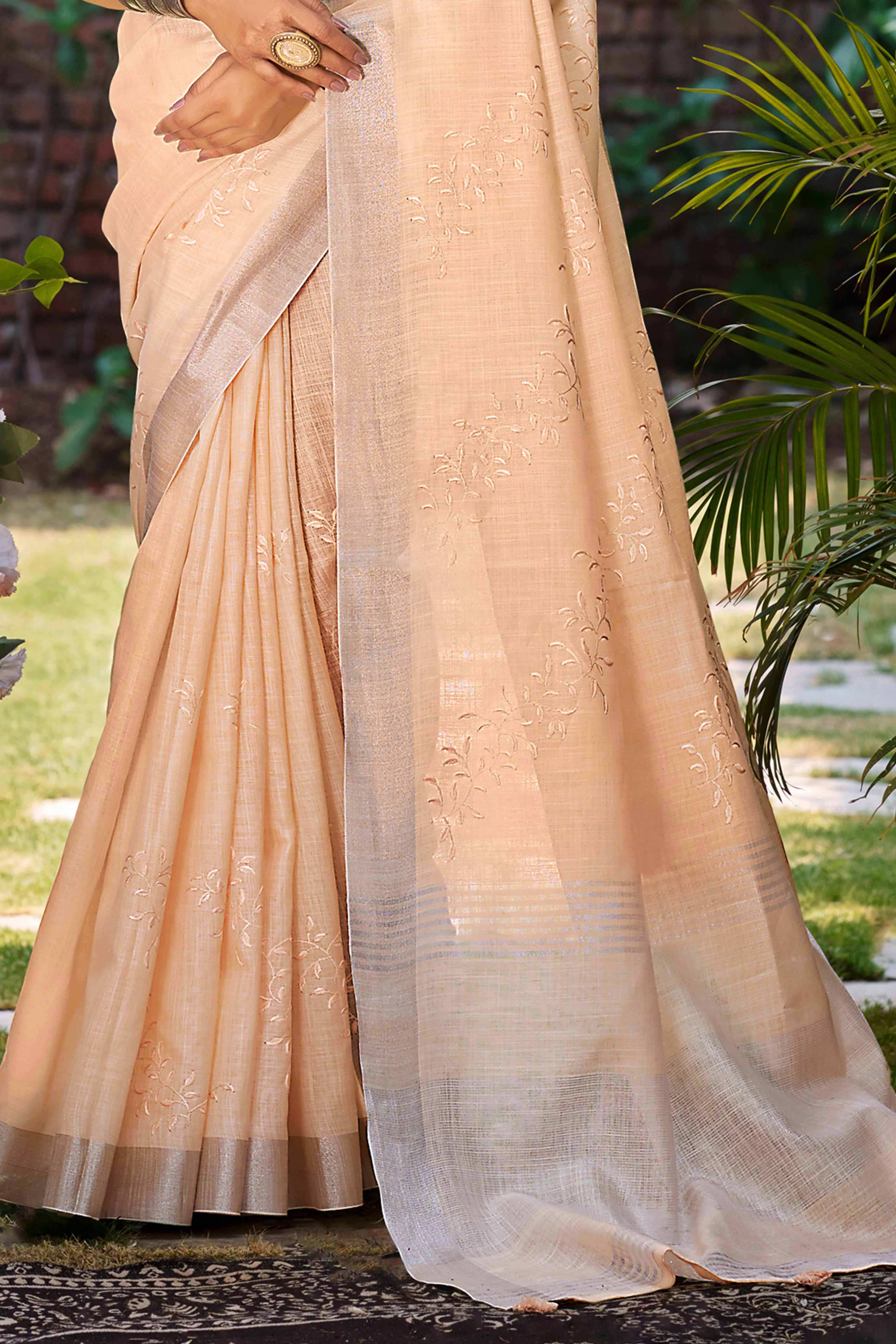 Elegant Peach Linen Saree Featuring Intricate Woven & Embroidered Patterns