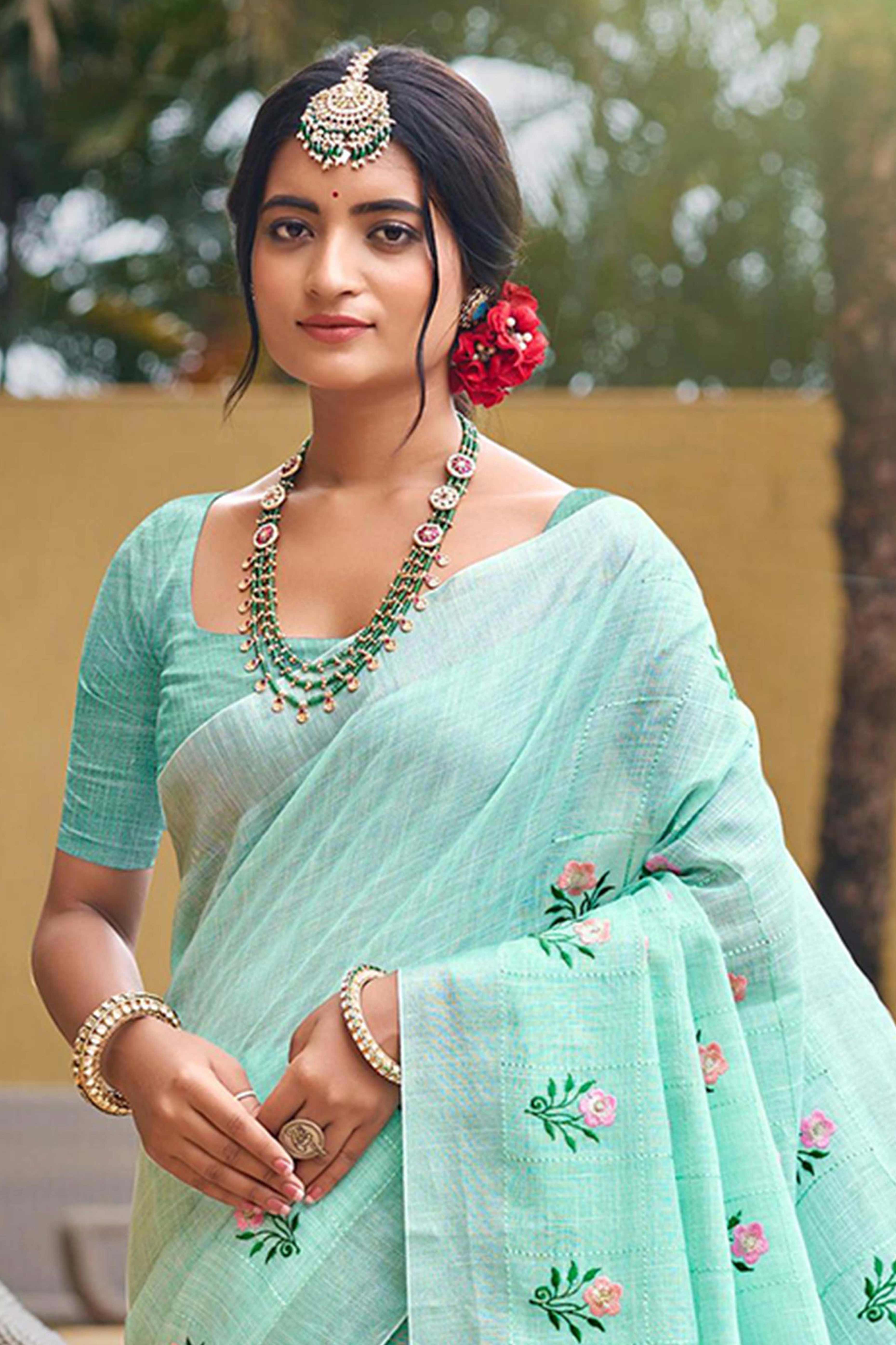 Captivating Turquoise Floral Thread Embroidered Linen Saree With Elegant Weaving Border