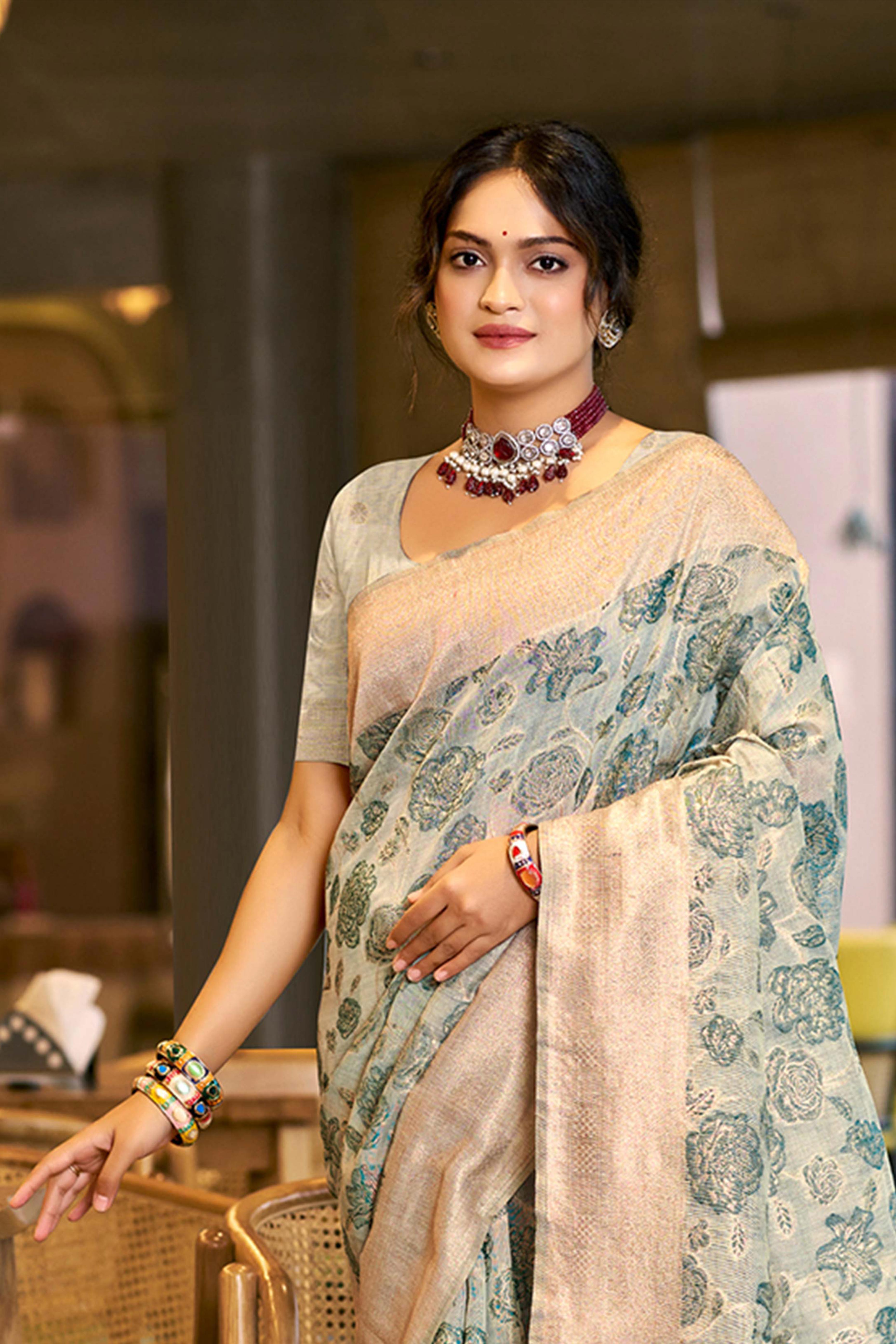 Teal Premium Cotton Silk Saree Highlighted With Floral Weaving Work & Tassel Pallu